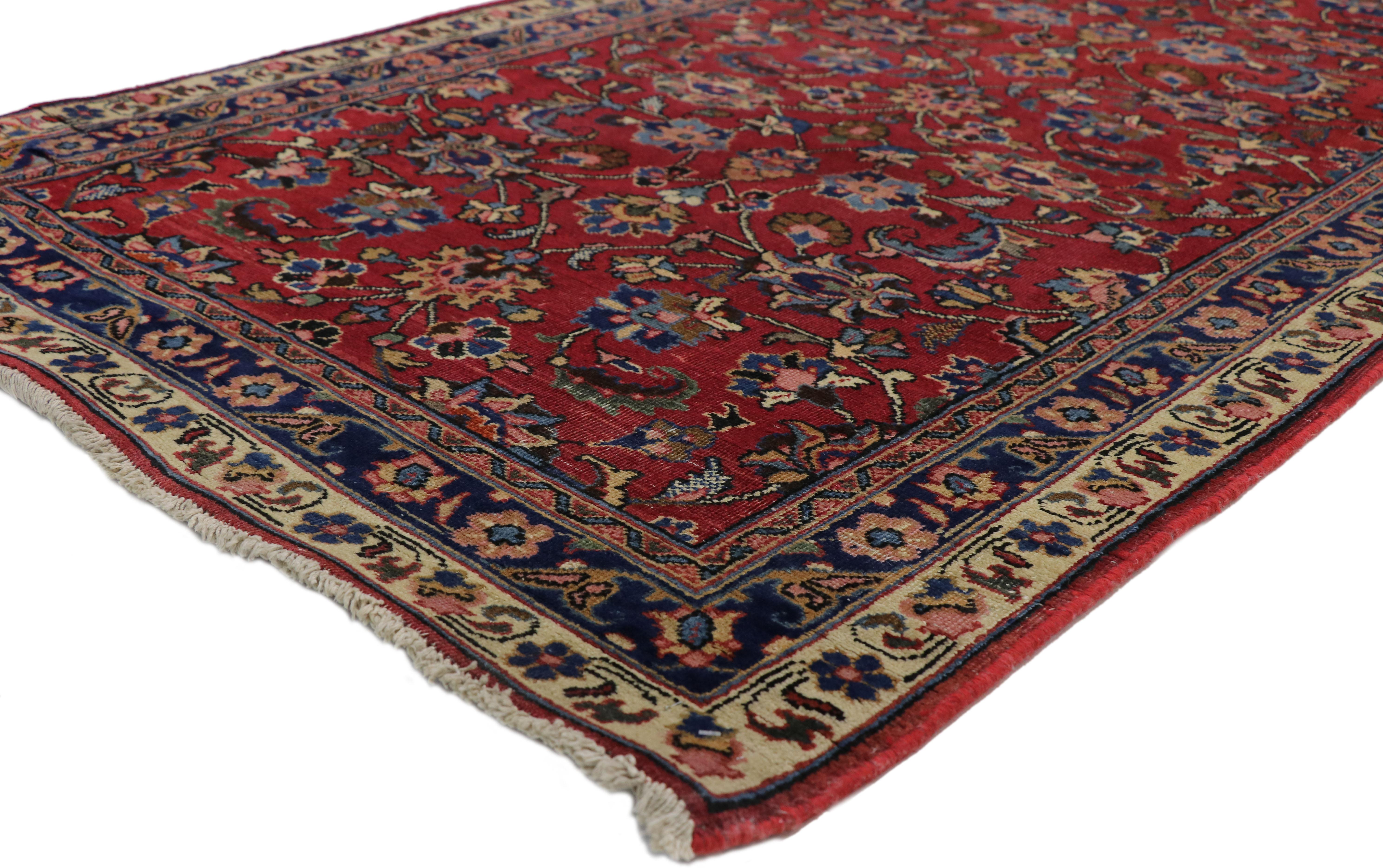 75353, vintage Persian Mashhad runner with Old World Parisian style. This hand knotted wool vintage Persian Mashhad runner features an all-over floral pattern composed of the Herati pattern spread across an abrashed field. The classic Herati