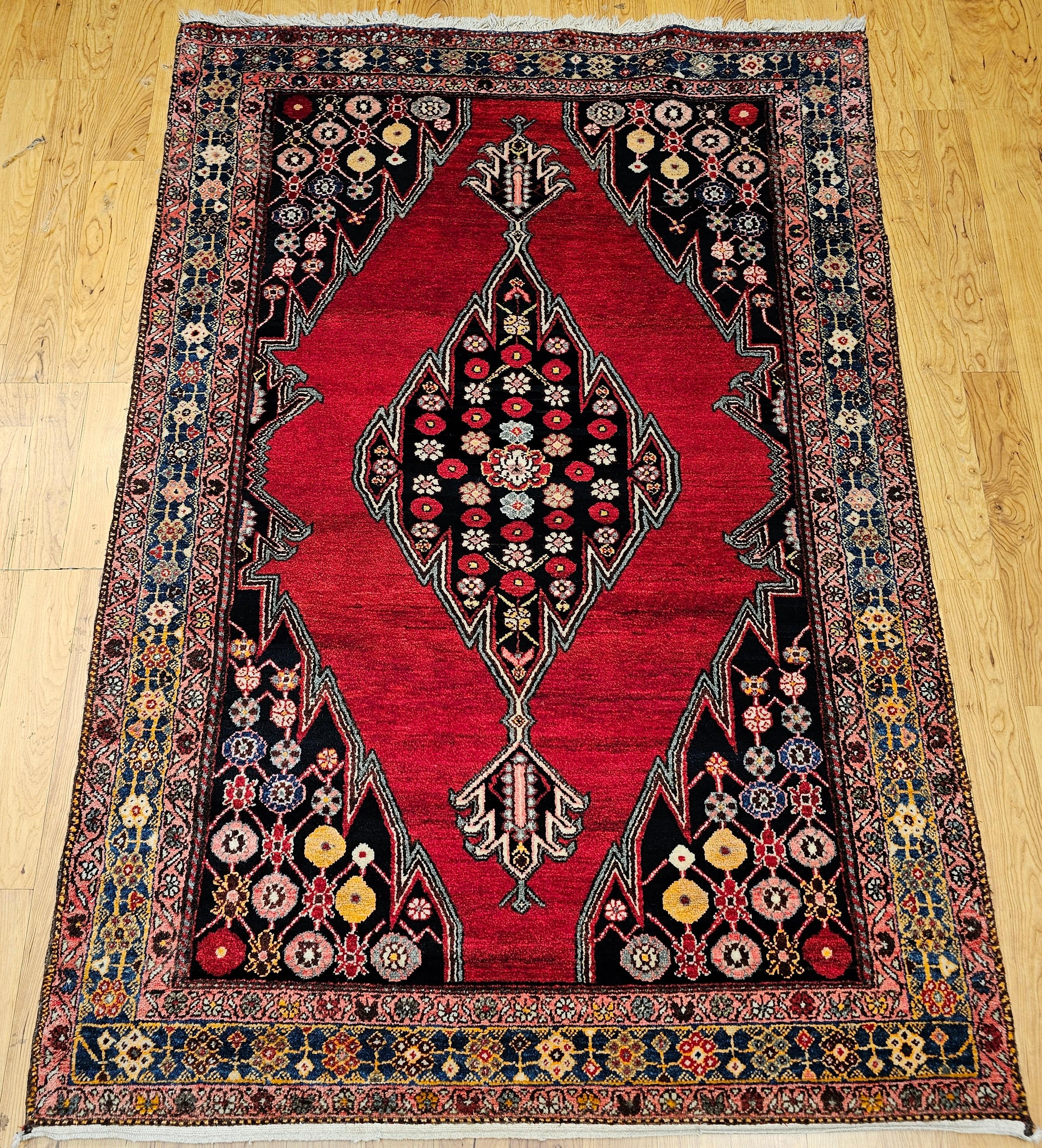 Schöner und farbenfroher persischer Mazgalan-Dorfteppich mit einem leuchtend roten Farbfeld mit einem länglichen zentralen Medaillonmuster, das mit geometrischen Formen in verschiedenen leuchtenden Farben gefüllt ist.  Das Design erinnert an das