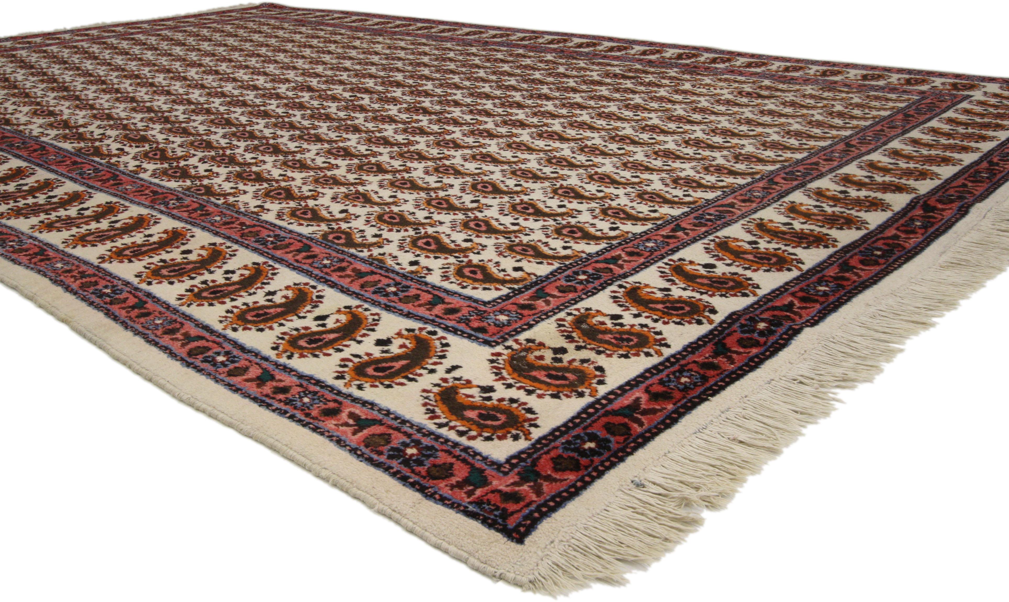 72007, vintage Persian Mood rug with all-over Boteh pattern. This hand-knotted wool vintage Persian Mood rug features an allover pattern of the boteh, or paisley, motif throughout the field and primary border. Two red and blue guard borders flank
