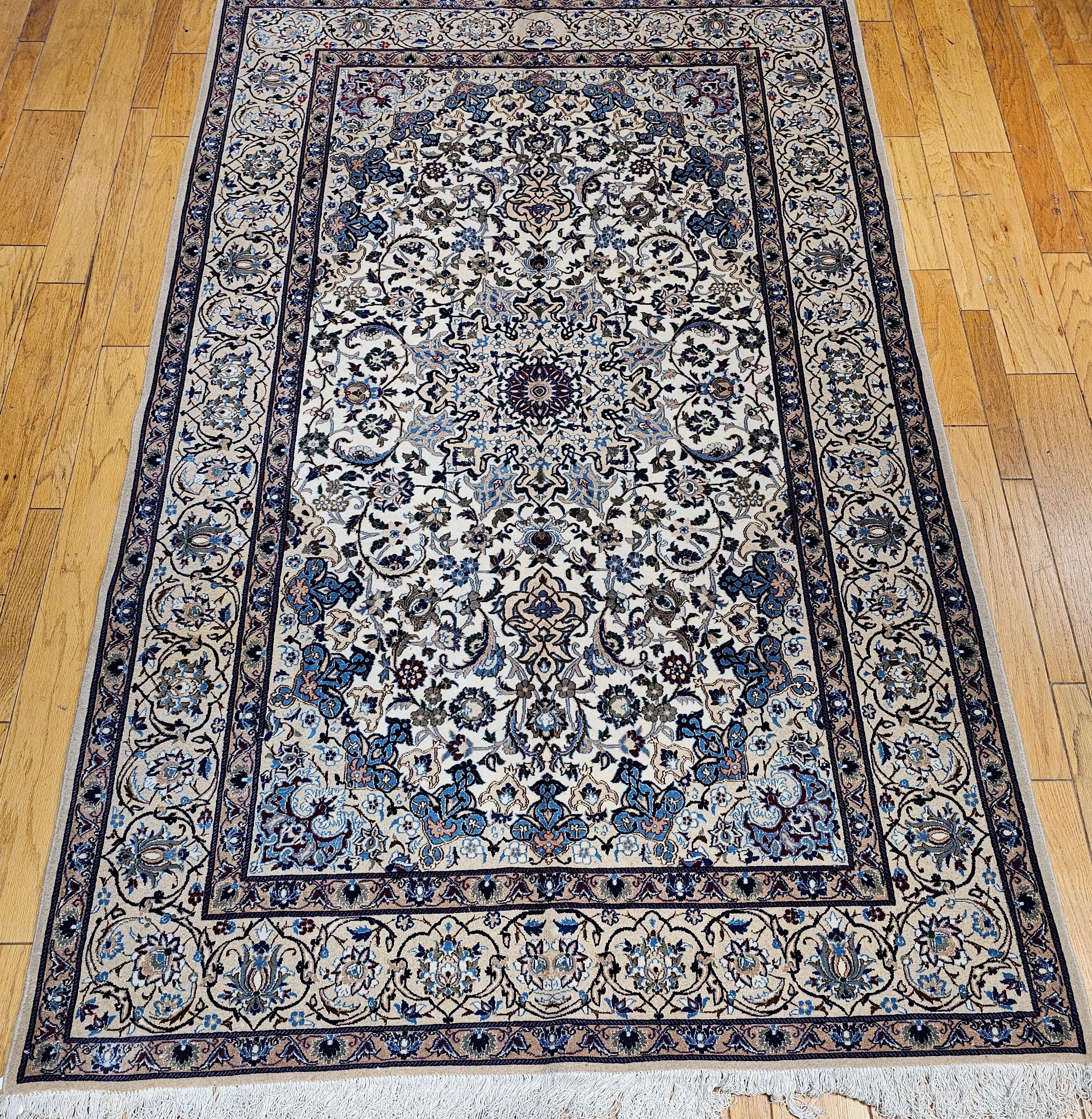  Vintage Persian Nain is in a very unique design and color palate. This Nain has a cream color field and beige color border in a floral pattern and a central medallion is very distinct from the typical Nain design. The use of organic vegetable dyes
