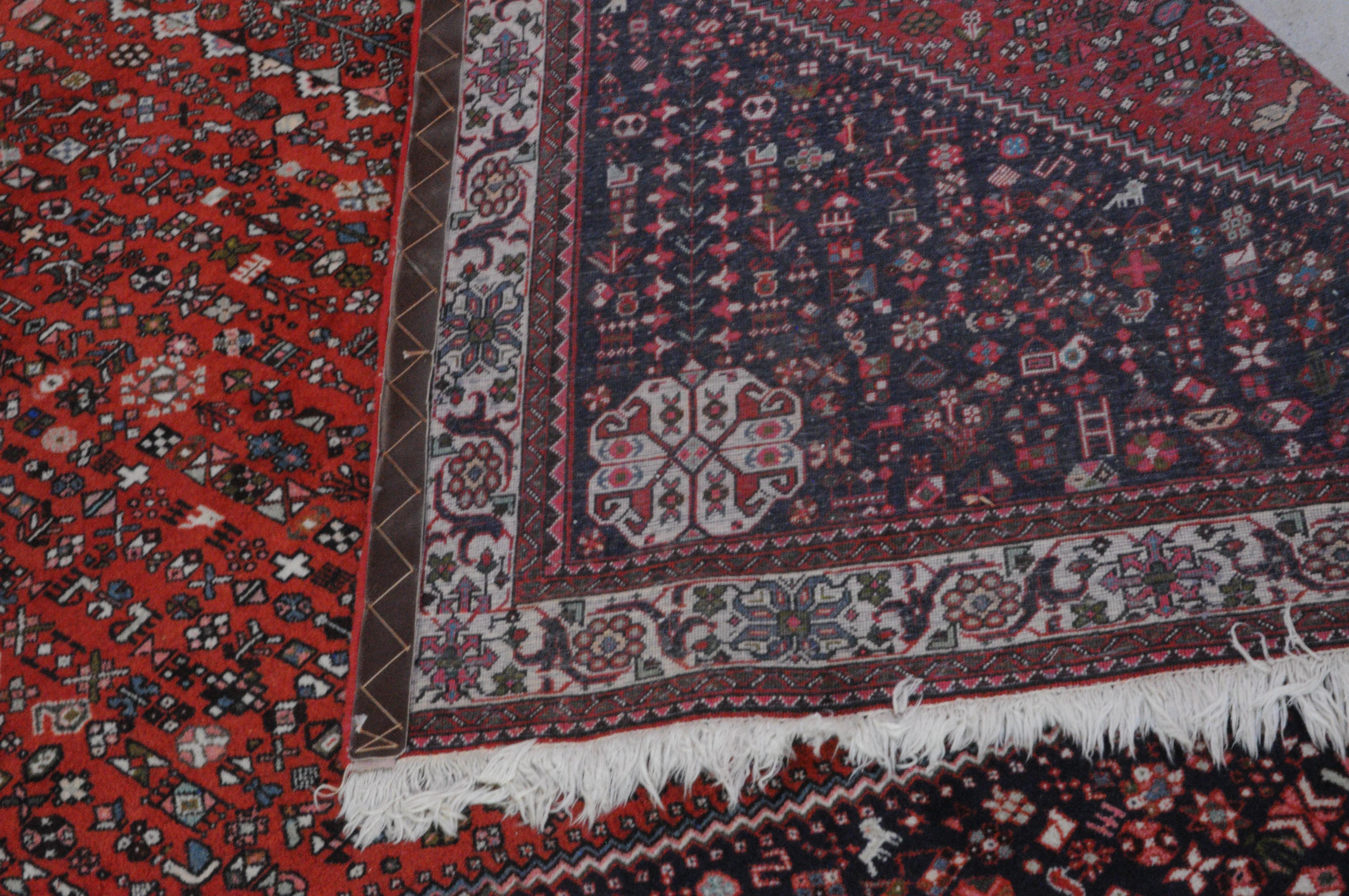 Geometric Shiraz tapestry / rug in attractive palette of red and navy with various accent colors, circa mid-20th century. Combination of geometric shapes and animal motifs present throughout. 
Very clean, vintage condition. 
Measures: 80