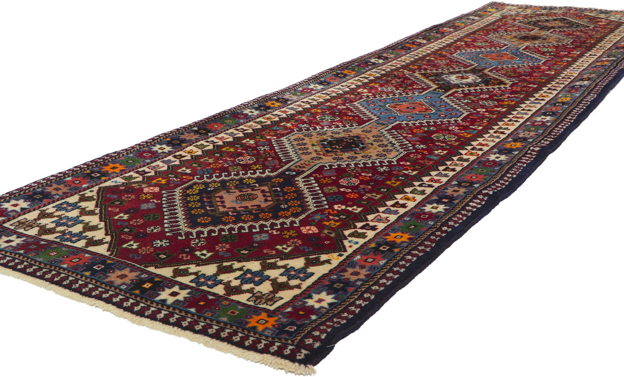 61044 Vintage Persian Shiraz Rug Runner, 02'10 x 10'07. Embark on an evocative journey as you delve into the rich embrace of this hand-knotted wool vintage Persian Shiraz rug. Envision the rugged artisan, skillfully weaving tribal enchantment into