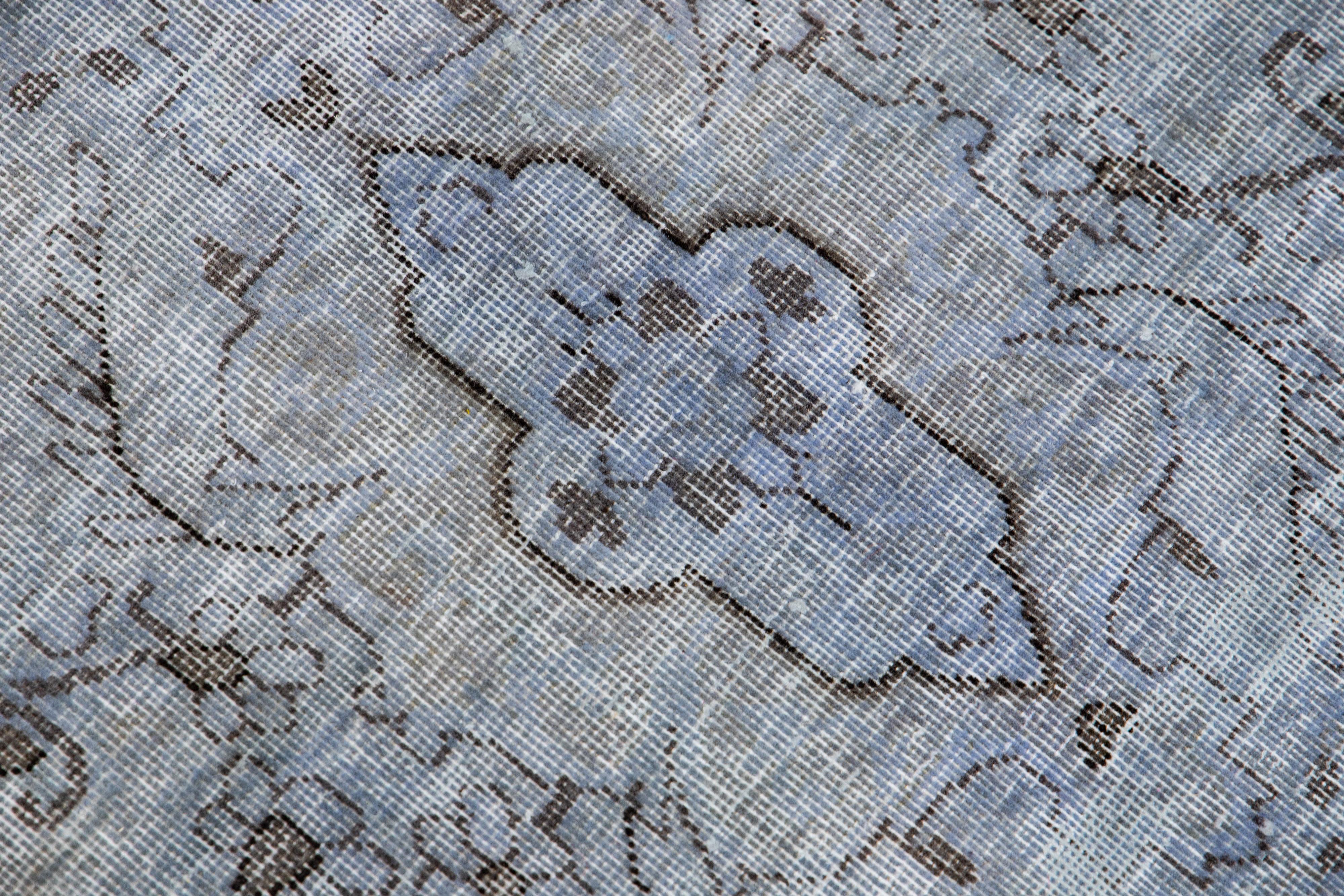 20th Century Vintage Persian Overdyed Handmade Floral Blue Wool Rug For Sale