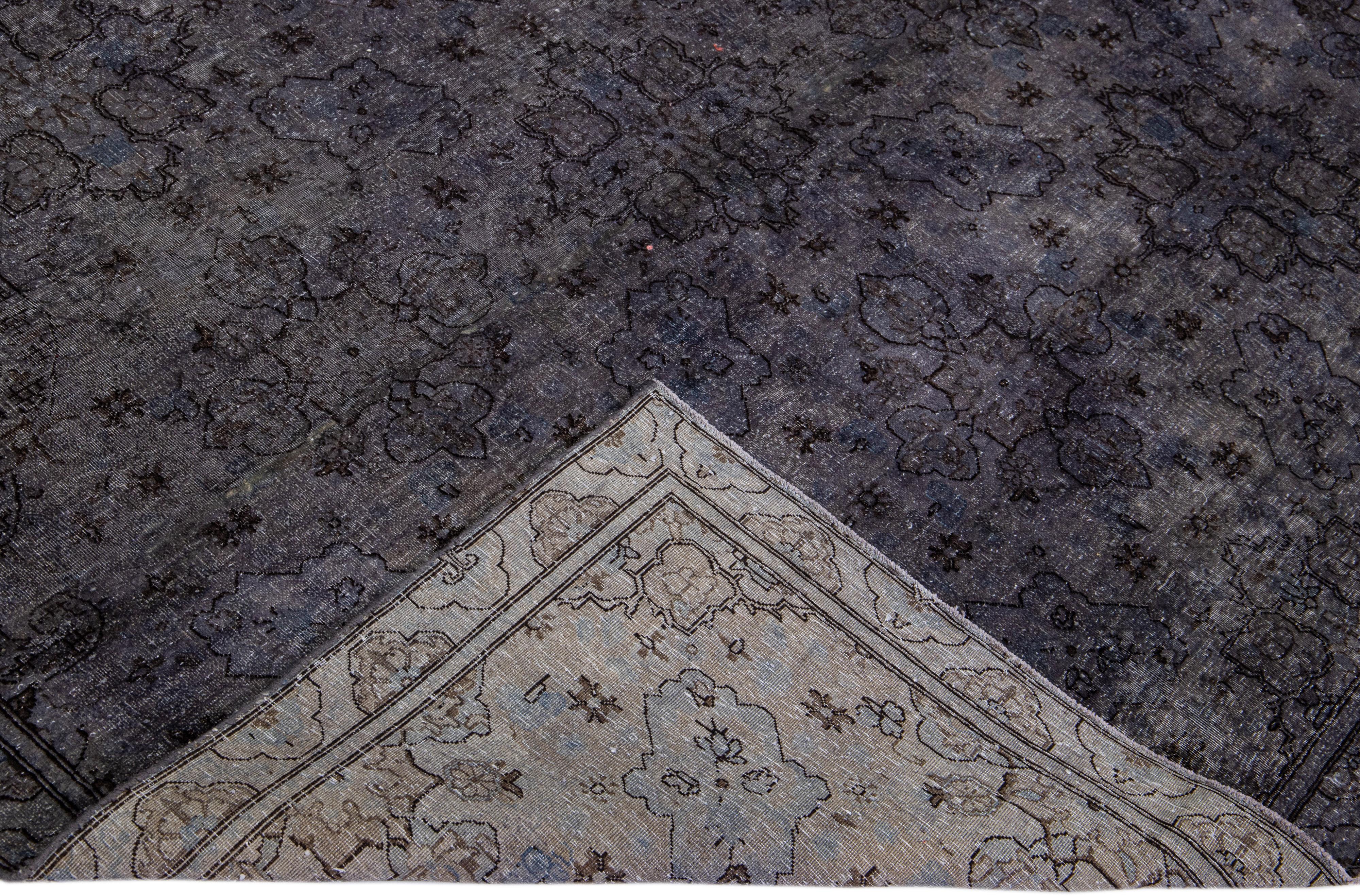 Beautiful vintage overdyed hand-knotted wool rug with a gray field. This Persian rug has black accents in an all-over floral design.

This rug measures: 6'9