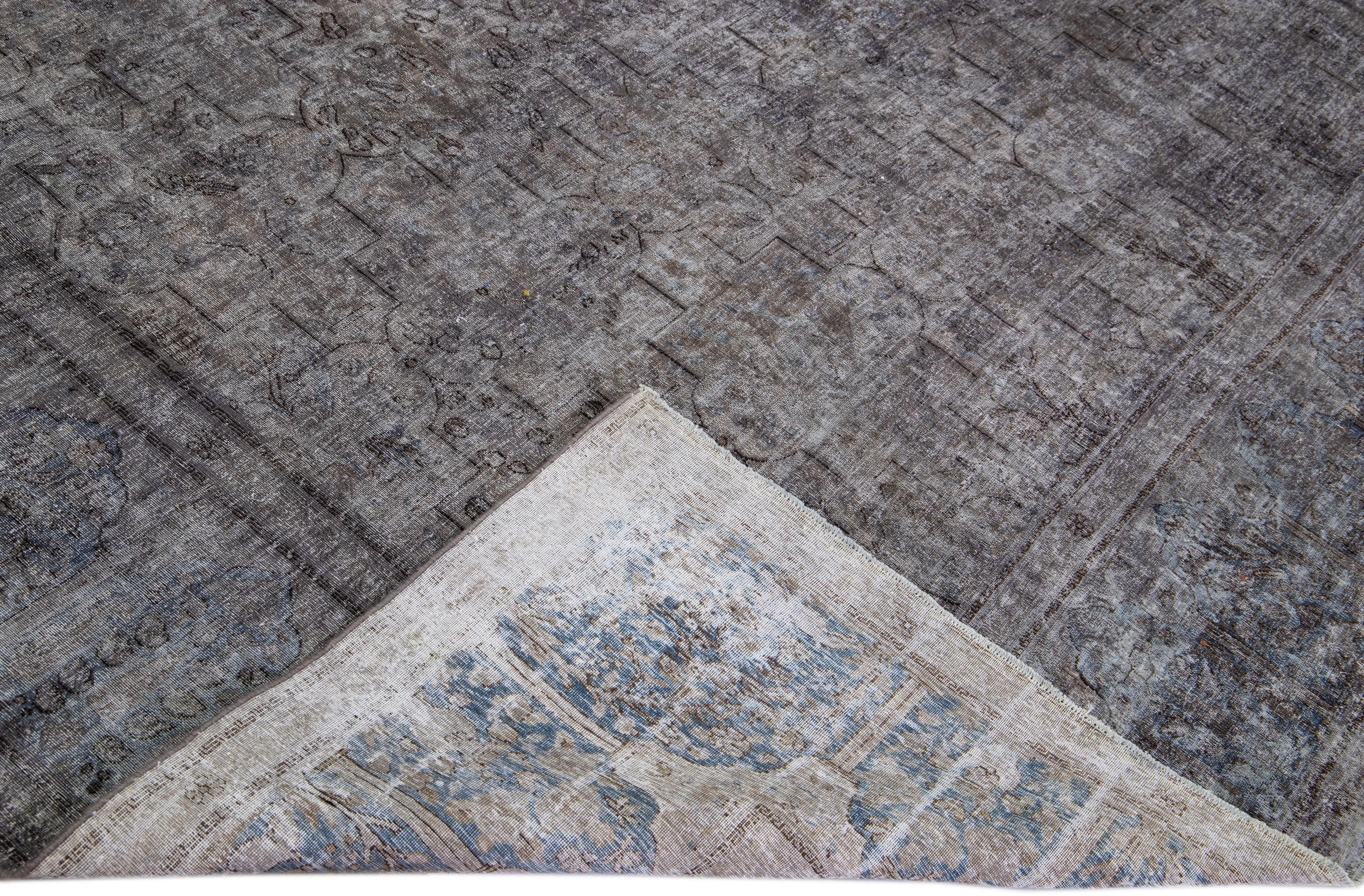 Beautiful Vintage Overdyed hand-knotted wool rug with a gray field. This Persian rug has blue and black accents in an all-over geometric design.

This rug measures: 9'7