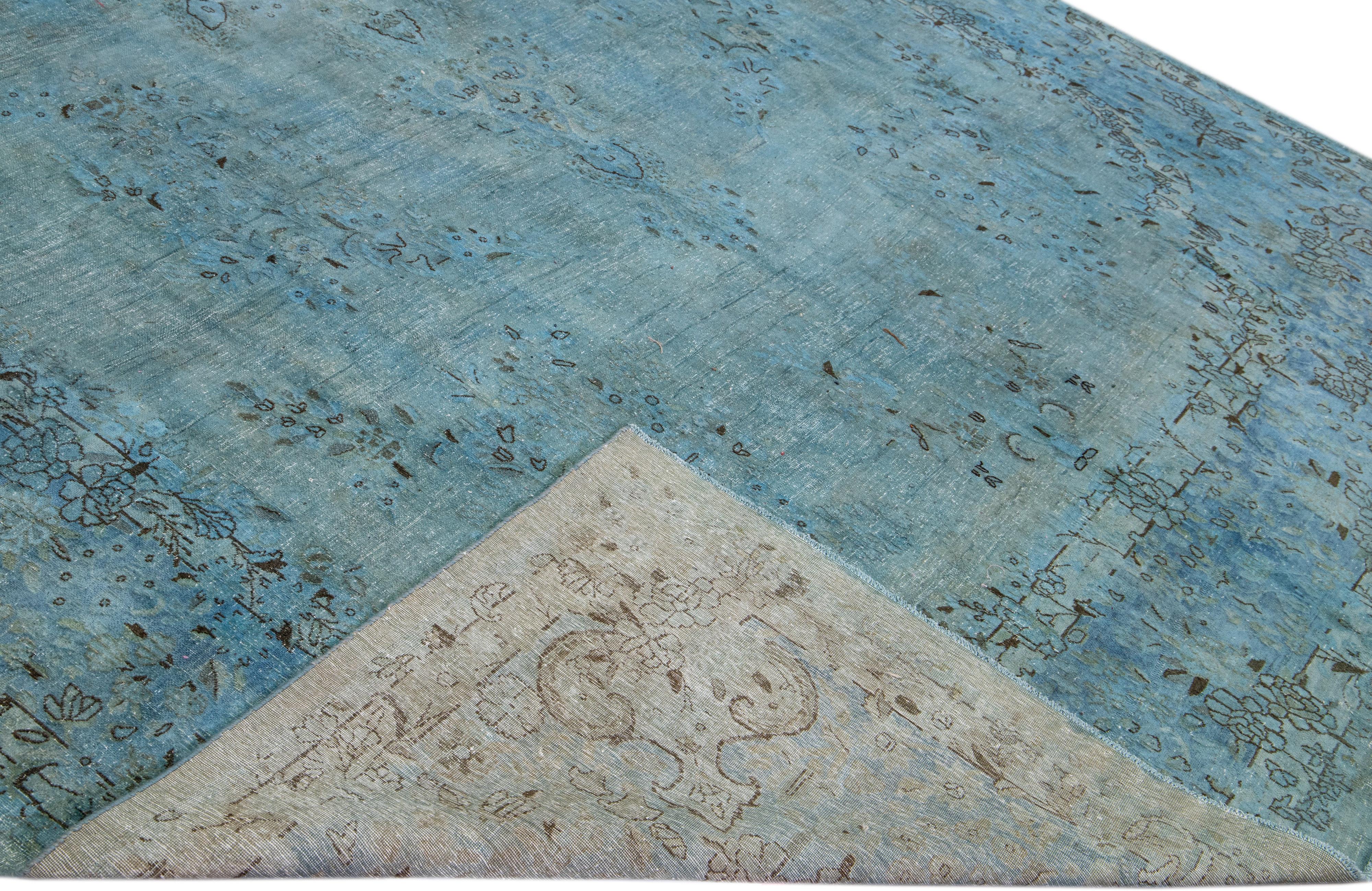 Beautiful vintage overdyed hand-knotted wool rug with a blue field. This Persian rug has black and gray accents in an all-over medallion design.

This rug measures: 9'8