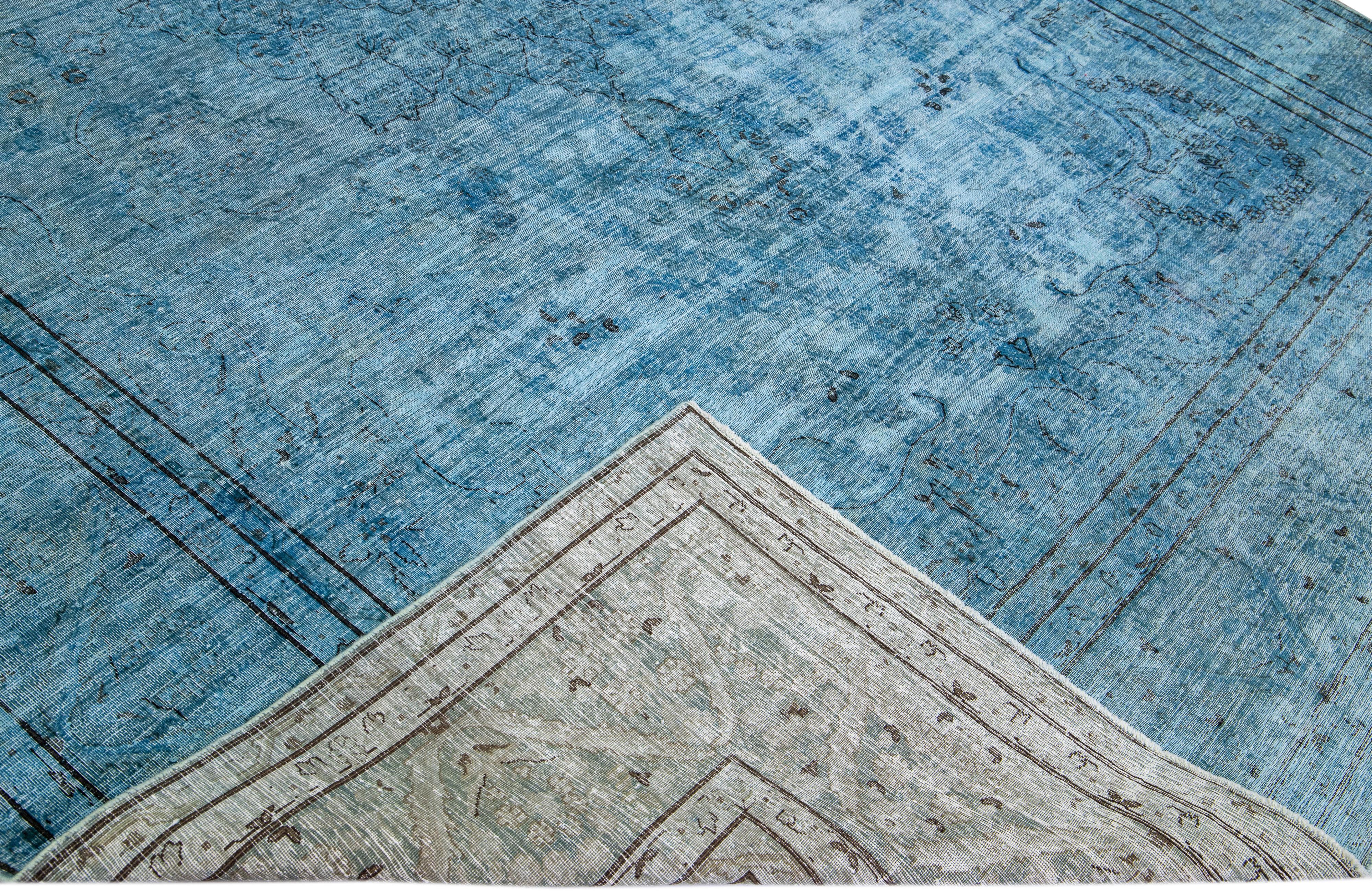 Beautiful Vintage Overdyed hand-knotted wool rug with a blue field. This Persian rug has black and gray accents in an all-over medallion design.

This rug measures: 9'5