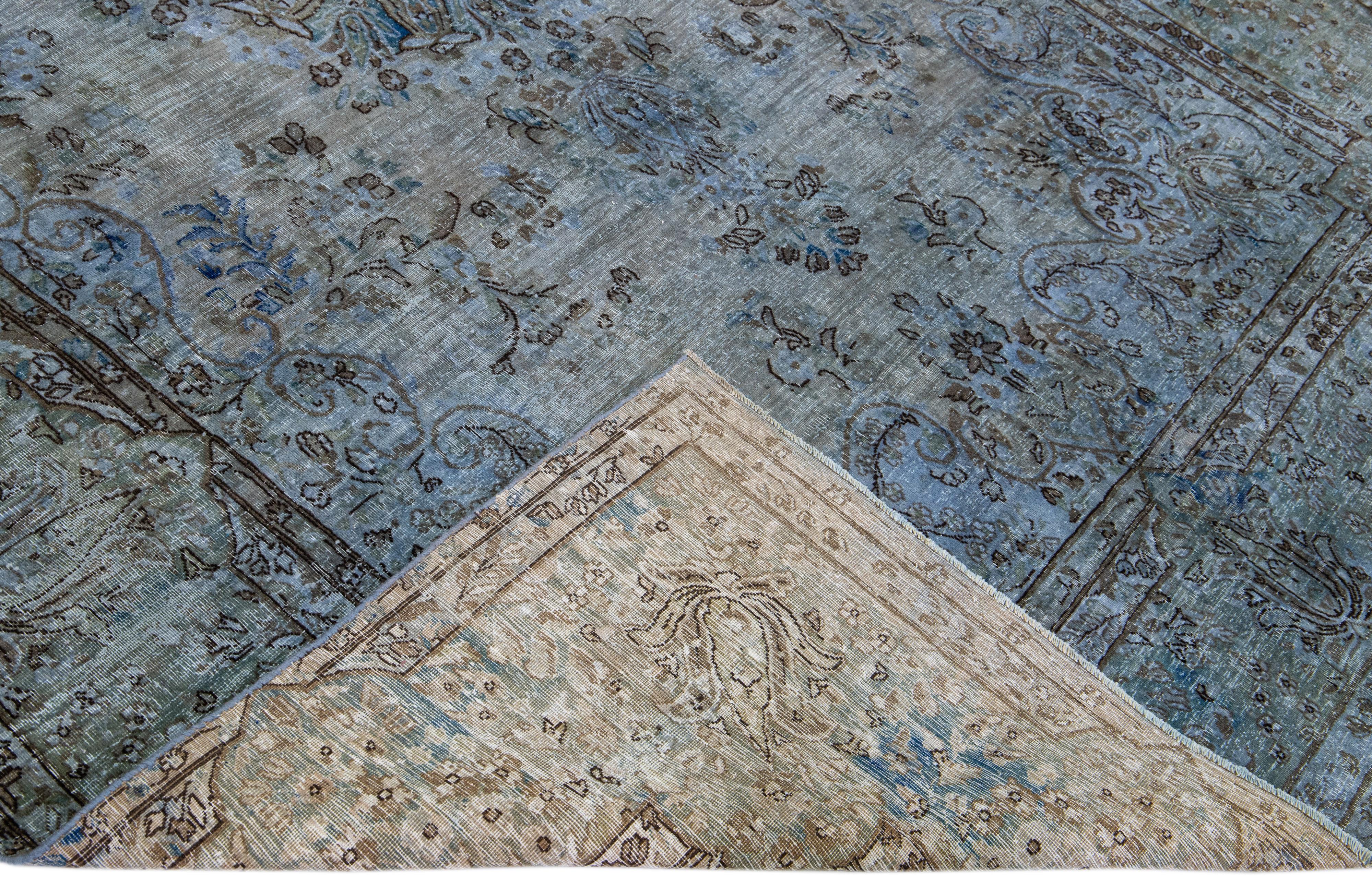 Beautiful Vintage Overdyed hand-knotted wool rug with a blue field. This Persian rug has black and gray accents in an all-over medallion design.

This rug measures: 7'2