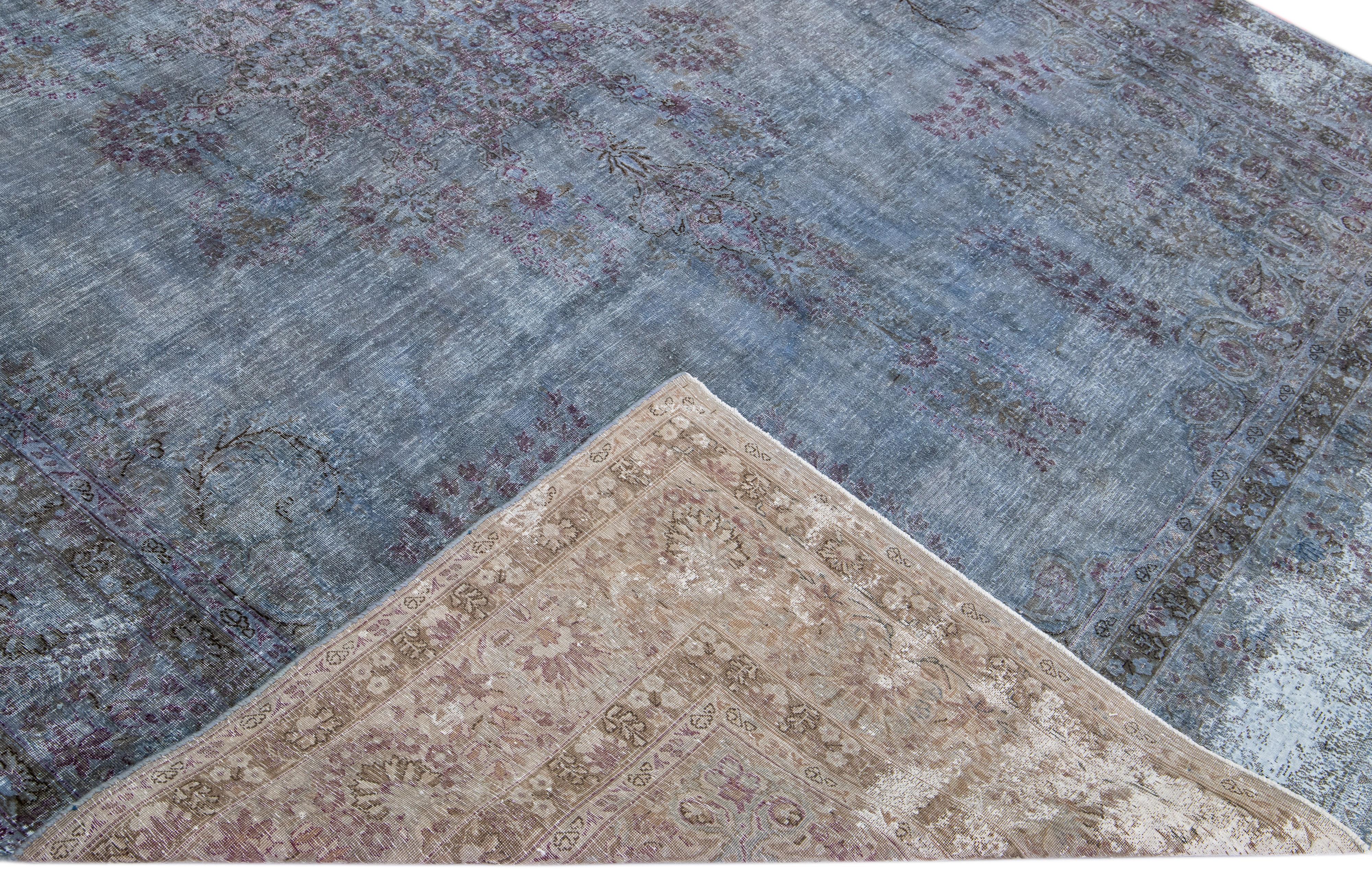 Beautiful Vintage Overdyed hand-knotted wool rug with a blue field. This Persian rug has purple and gray accents in an all-over medallion design.

This rug measures: 8'3
