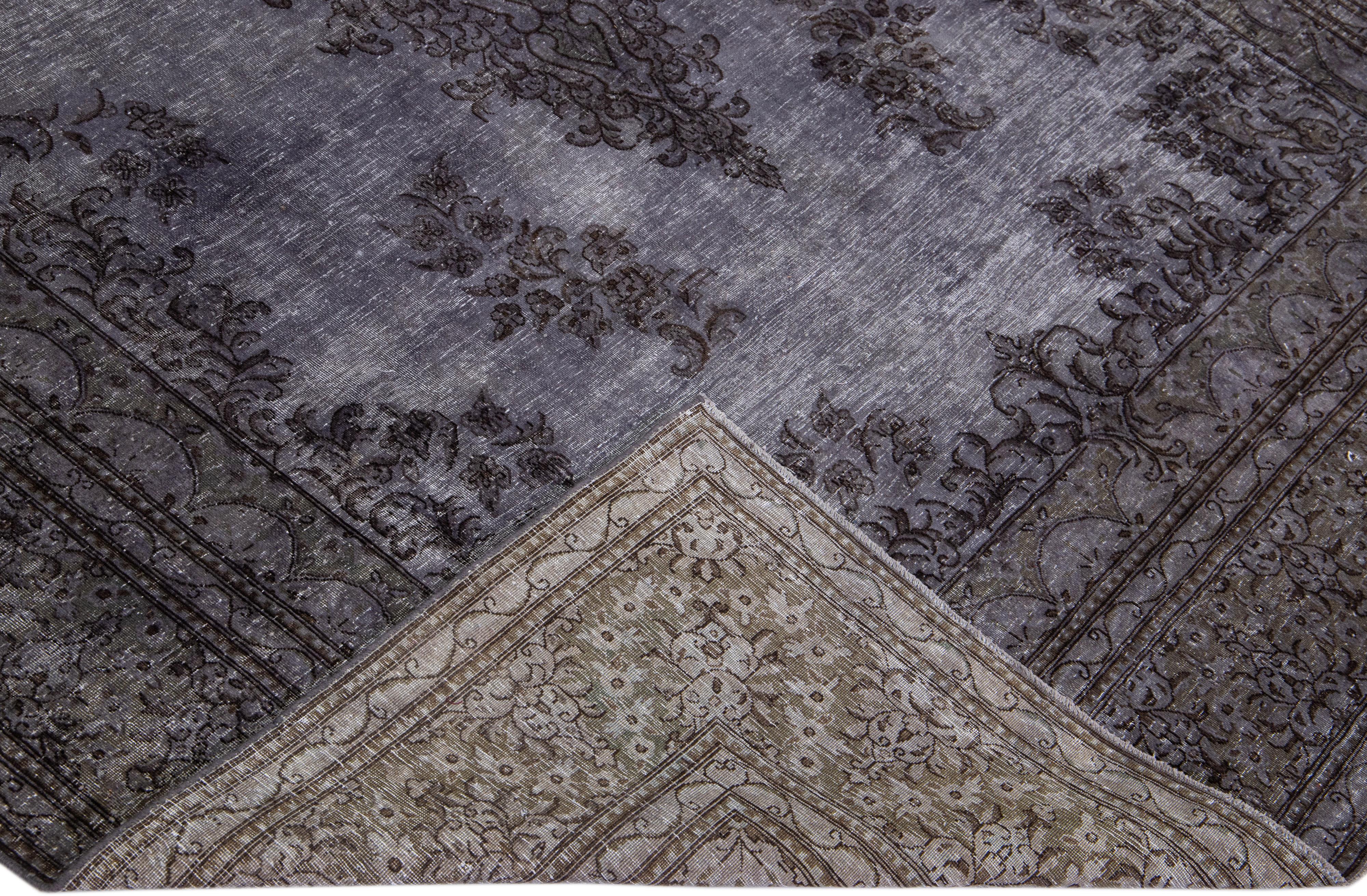 Beautiful vintage Overdyed hand-knotted wool rug with a gray field. This Persian rug has black accents in an all-over medallion design.

This rug measures: 6'11