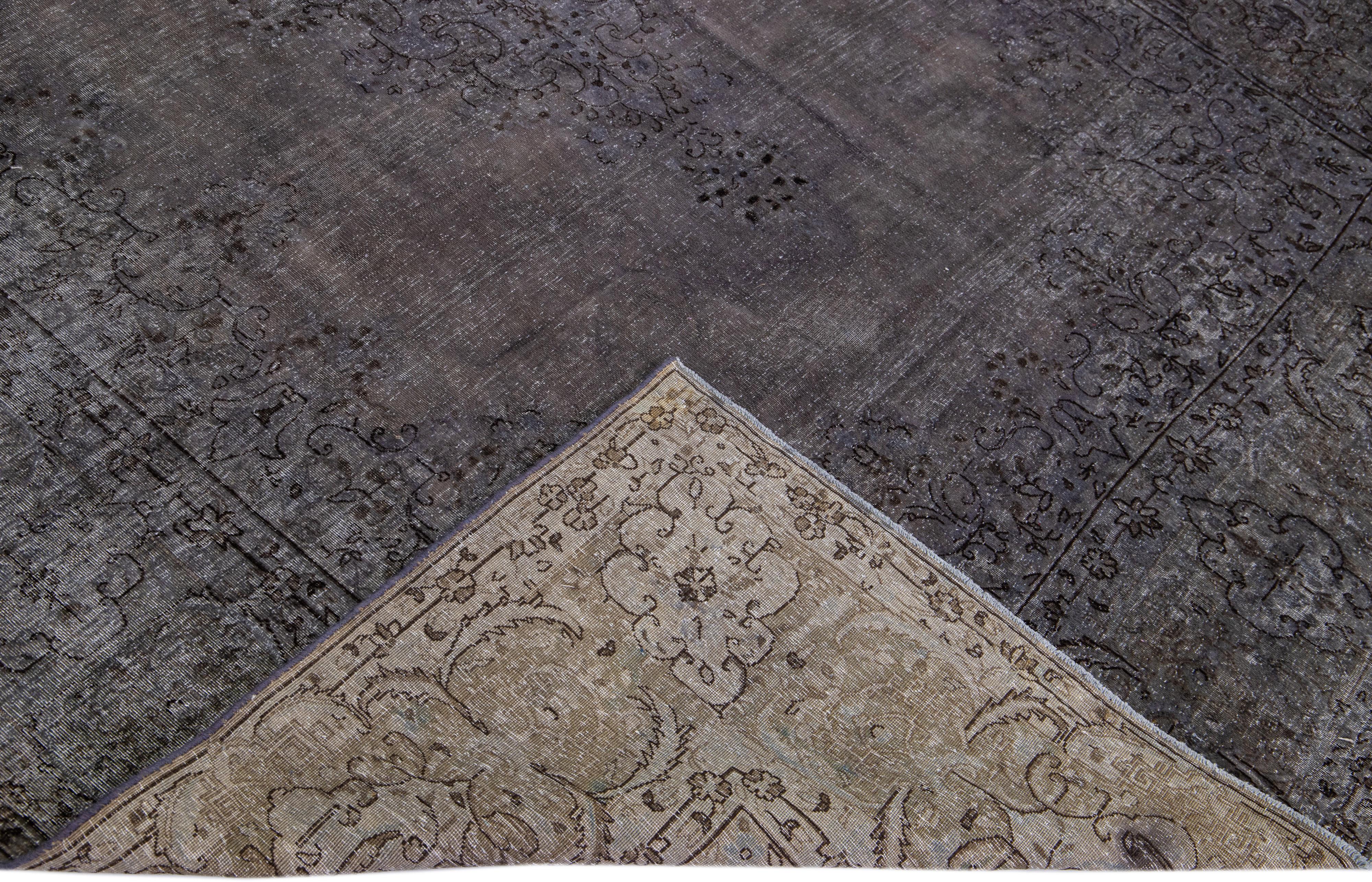 Beautiful Vintage Overdyed hand-knotted wool rug with a grey field. This Persian rug has black and brown accents in an all-over medallion design.

This rug measures: 7'7