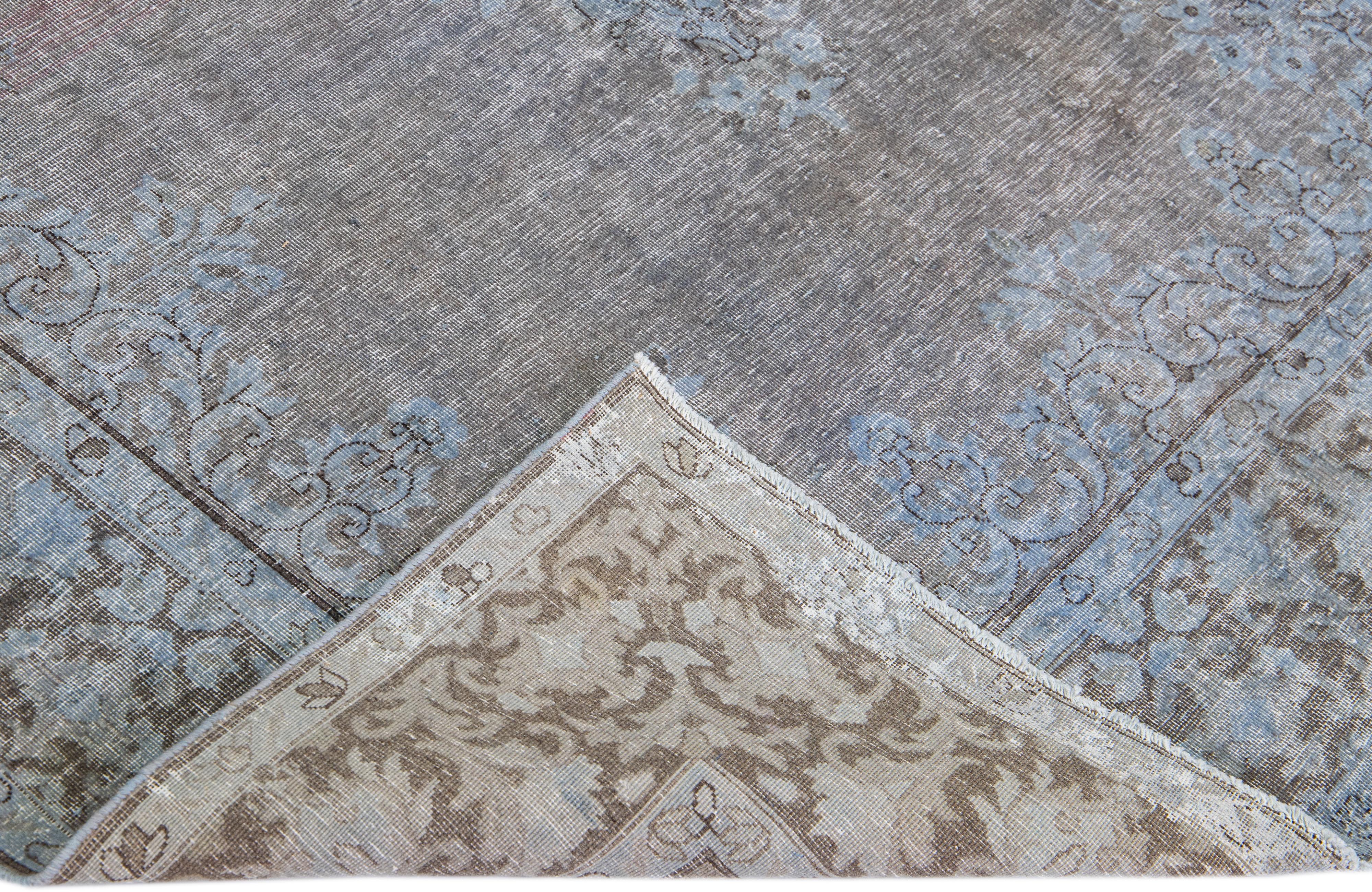Beautiful Vintage Overdyed hand-knotted wool rug with a gray field. This Persian rug has blue accents in an all-over medallion design.

This rug measures: 5'9'' x 8'8