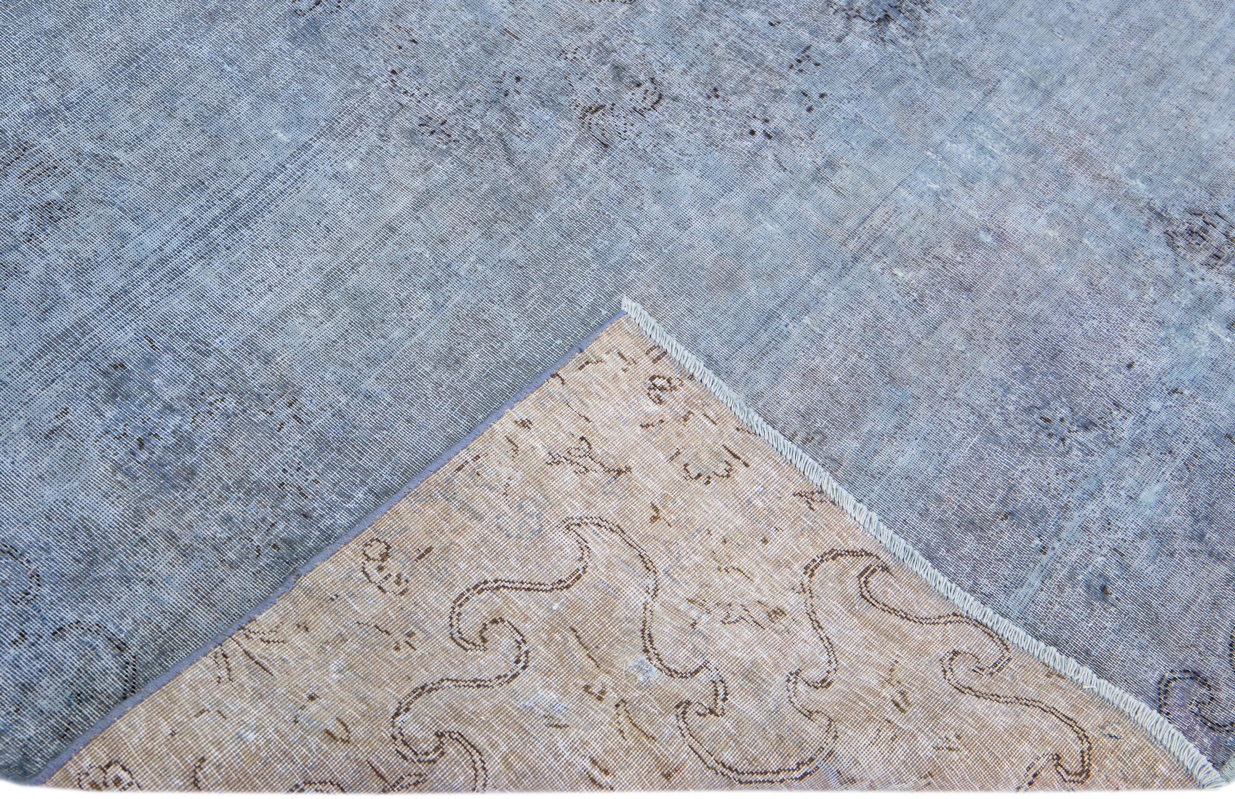 Beautiful Vintage Overdyed hand-knotted wool rug with a blue field. This Persian rug has black and gray accents in an all-over medallion design.

This rug measures: 5'11