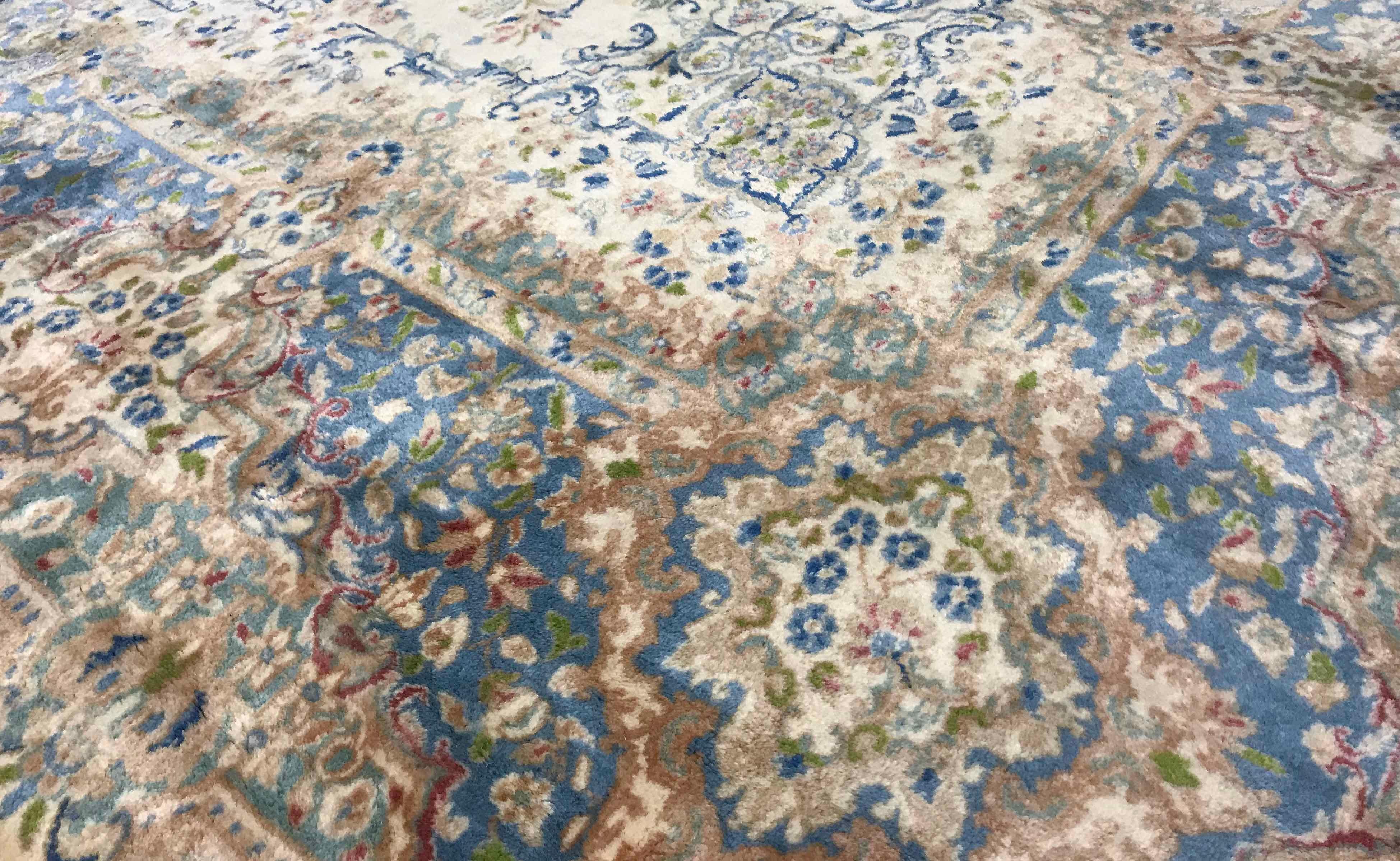 Vintage Persian oversize Kerman rug circa 1940.This attractive oversized Kerman has an ivory ground enclosing a central floral design in soft pastel blues with the floral theme surrounding the central field the main border continues the soft blue