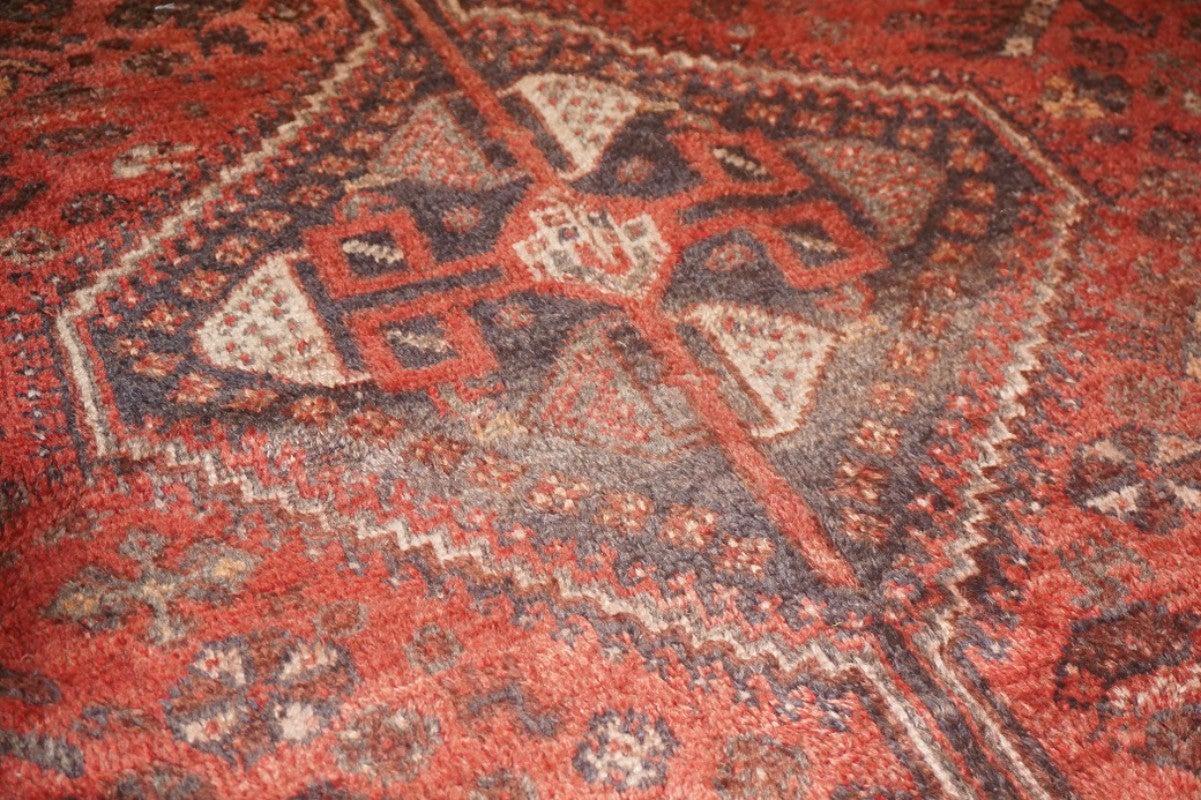 Vintage rug red. This vintage Persian Qashqa'i carpet is an elaborate piece of art with geometric abstractions, grey, green, a hint of orange and yellow against a rich red field. It is a unique vintage early 20th century carpet that will add a bold