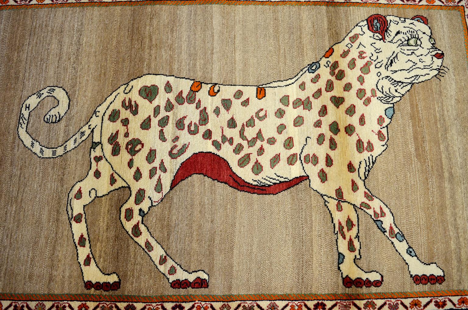 This vintage Persian Qashqai leopard animal carpet, circa 1930 in pure handspun wool and organic vegetable dyes has a unique coloration of undyed cream, beige and gray wools and contrasting dyed red, burgundy and light blue tones. The leopard’s