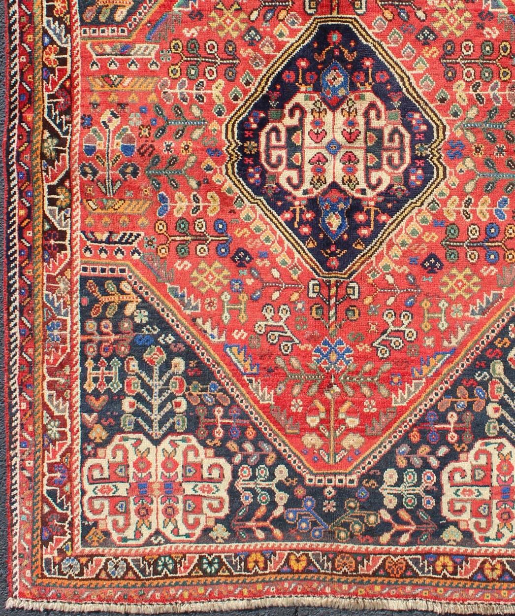 This multicolored Persian rug features an all-over background accompanied by a central medallion in vivid colors.
Measures: 4'1 x 6'0.