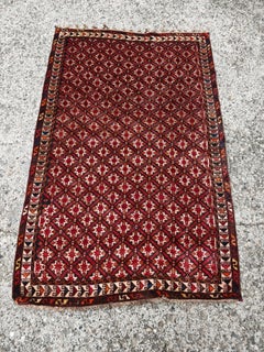Vintage Persian Qashqai rug, hand-woven in brick red wool in the 1940s