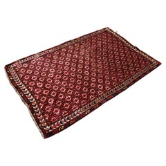 Vintage Persian Qashqai rug, hand-woven in brick red wool in the 1940s