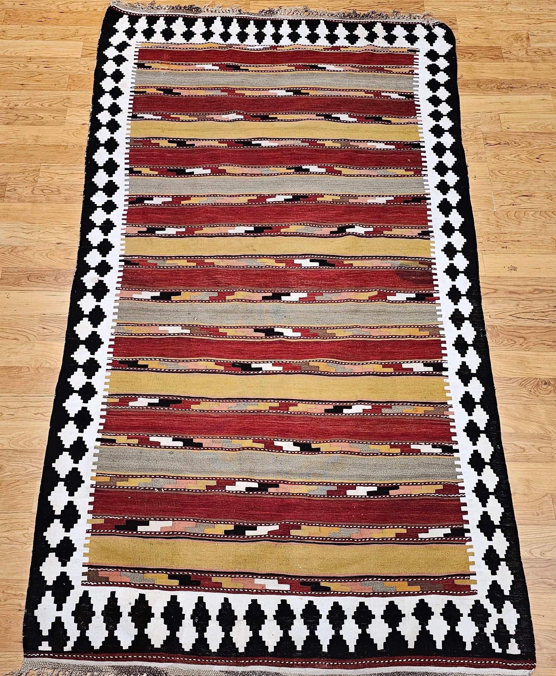 Beautiful and highly desirable Persian Qashqai tribal kilim rug from the early 1900s from southwest Persia.  The primary colors are yellow, green, red, ivory and brown.  The Qashqai kilims are known for their extremely fine weave and wonderful ultra