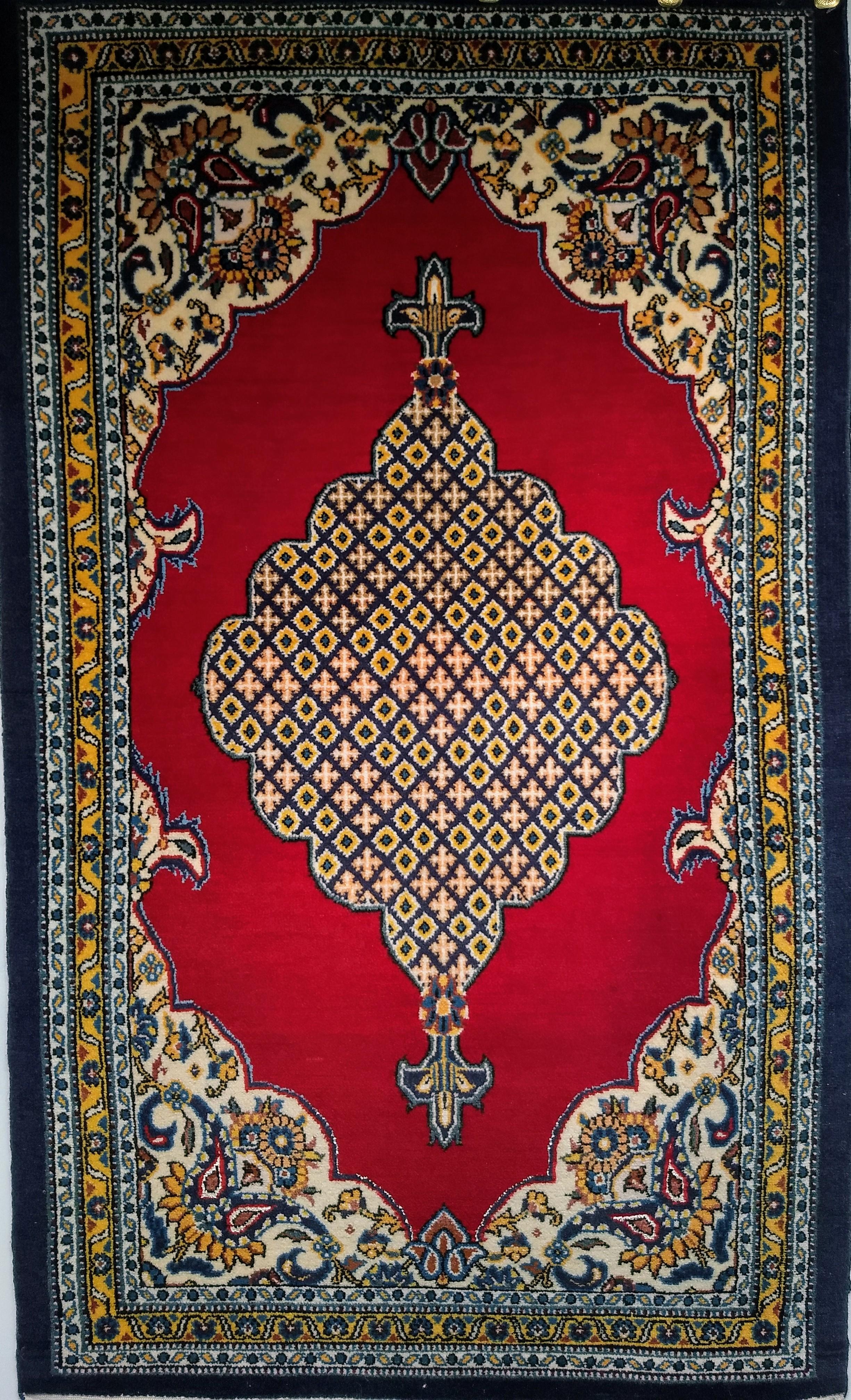 Vintage Persian Qum area rug in a geometric medallion pattern circa the mid 1900s.  The strikingly beautiful bright red field sets the stage to showcase this wonderful small area rug from one of the finest weaving centers in Persia.  The beautiful