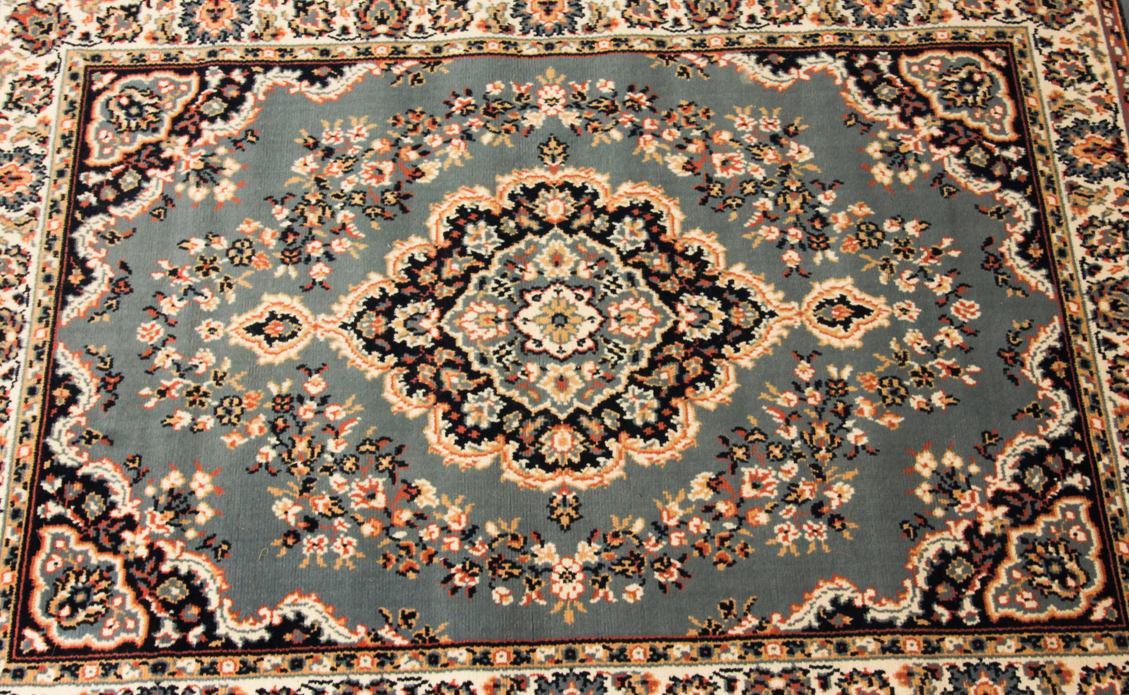 This very elegant fine quality vintage Persian rug was retailed by Mastercraft of Lascashire and dates from the last quarter of the 20th century.
 
This beautiful carpet was machine woven, it features a black and sapphire blue with medallions in