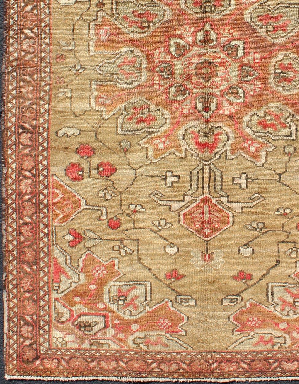 Vintage Tribal Persian, rug H-1006-08, country of origin / type: Persian / Tribal, circa mid-20th Century.

This gorgeous vintage Persian rug features a large-scale, multicolored light green, tan, brown and coral floral design complemented by a