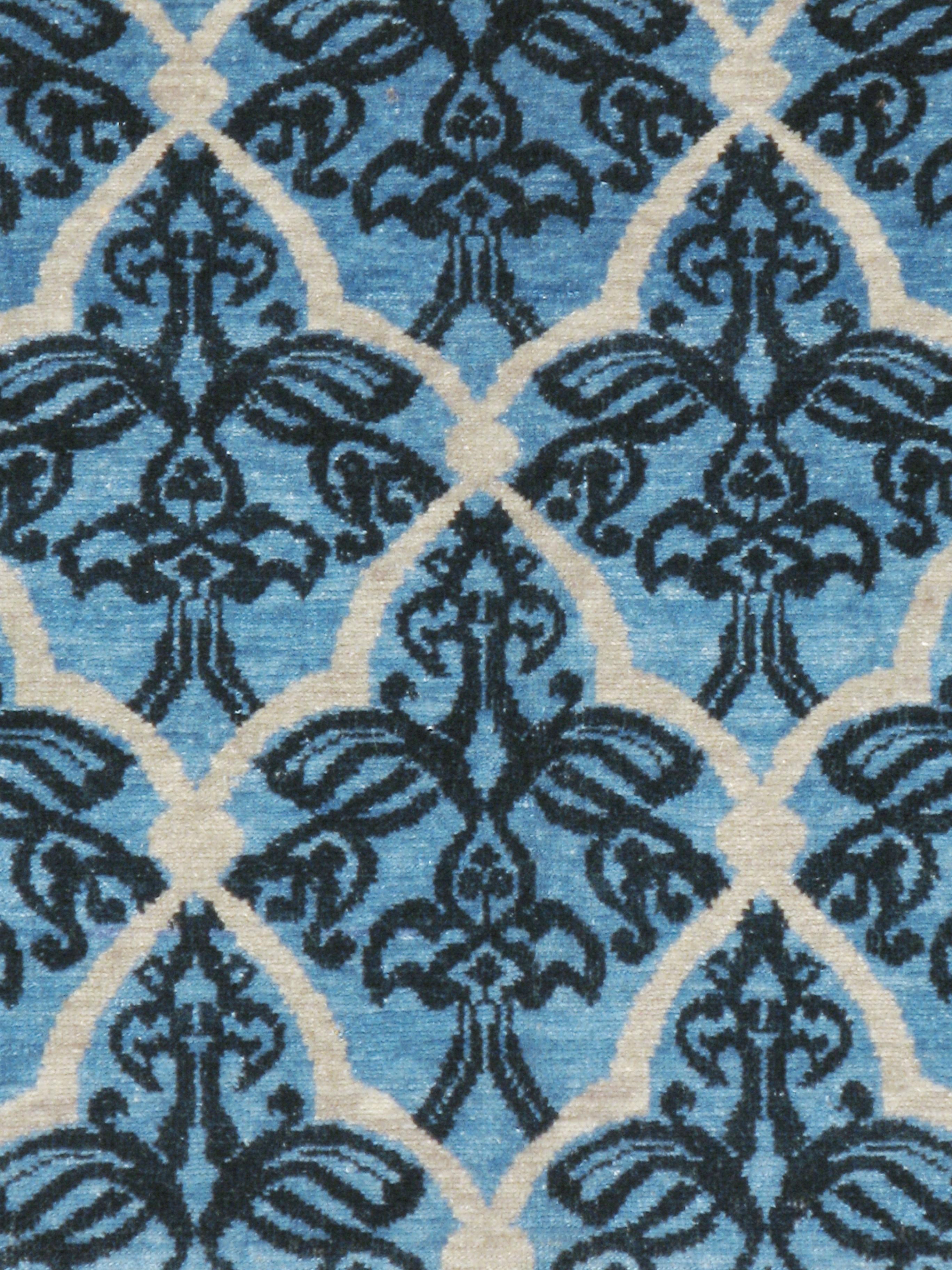 A vintage Persian modernist Malayer carpet from the mid-20th century. A shaped, diagonal all-over ecru lattice on a light blue, borderless field displays black outlined flowers incorporating fleur-de-lys motives. The lattice cells are halved at the