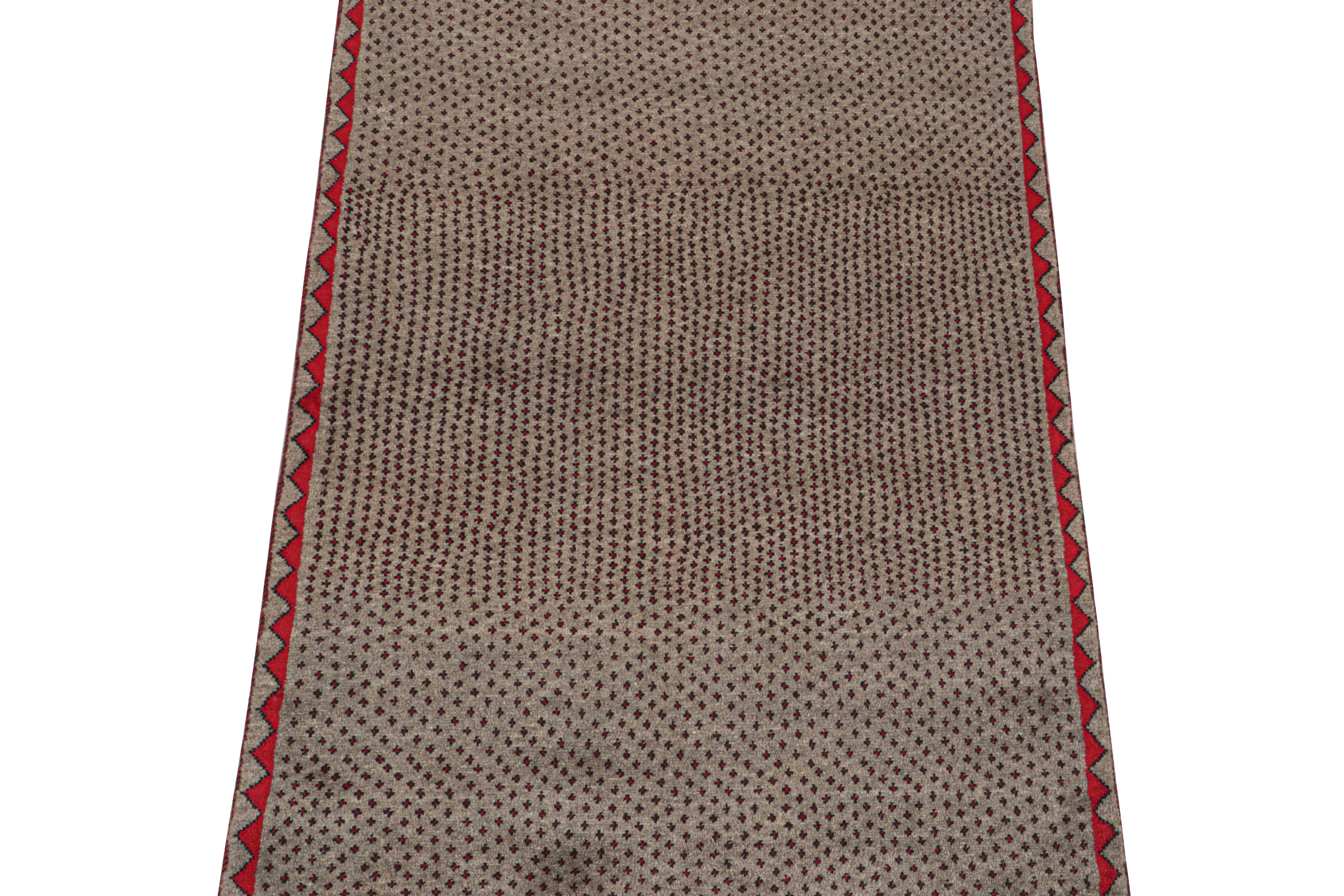 This vintage 3x5 Persian rug is a mid-century tribal piece, hand-knotted in wool circa 1950-1960.

Its design enjoys a fine all-over geometric pattern in red and black over a beige field with taupe notes. Keen eyes will further admire dark green