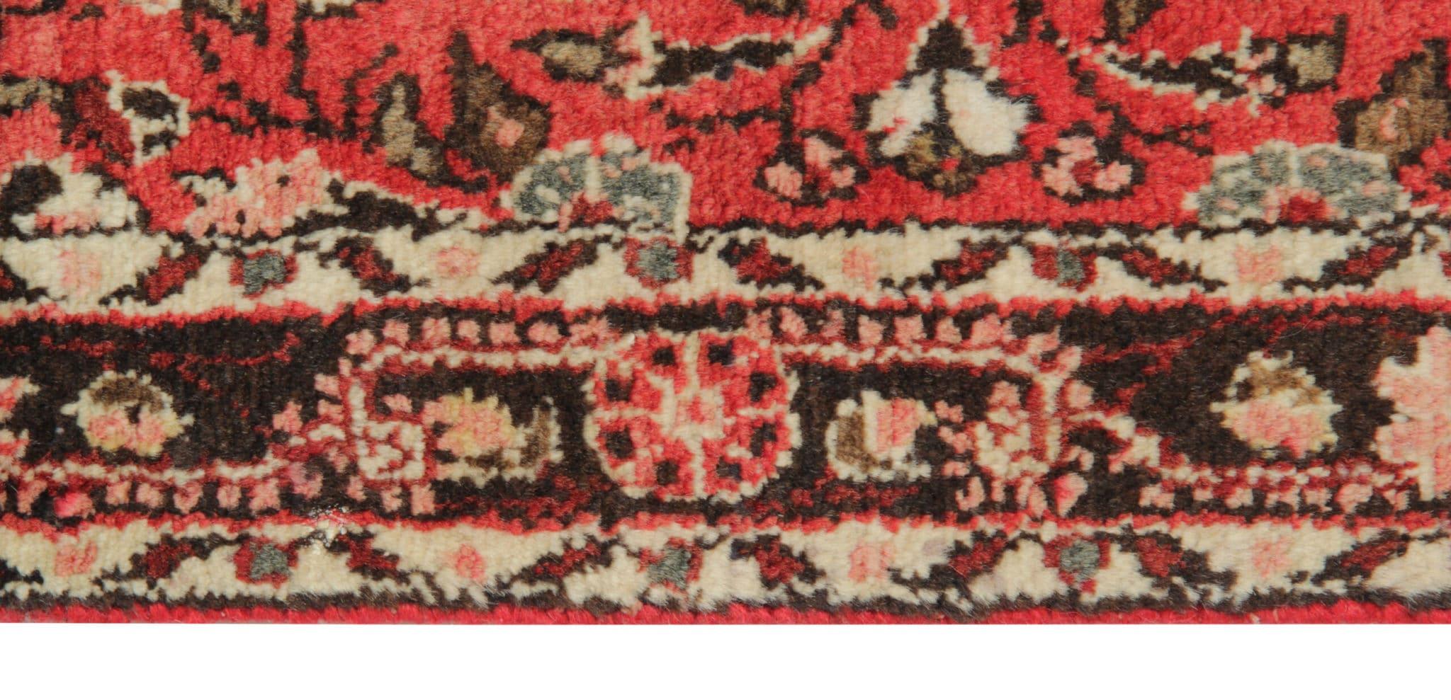 Enhance the charm of your living space with our captivating vintage floral runner rug in rust pink from 1950's. Skilfully hand-knotted, this rug boasts exceptional quality and timeless appeal. Crafted from a blend of wool and cotton, it offers both