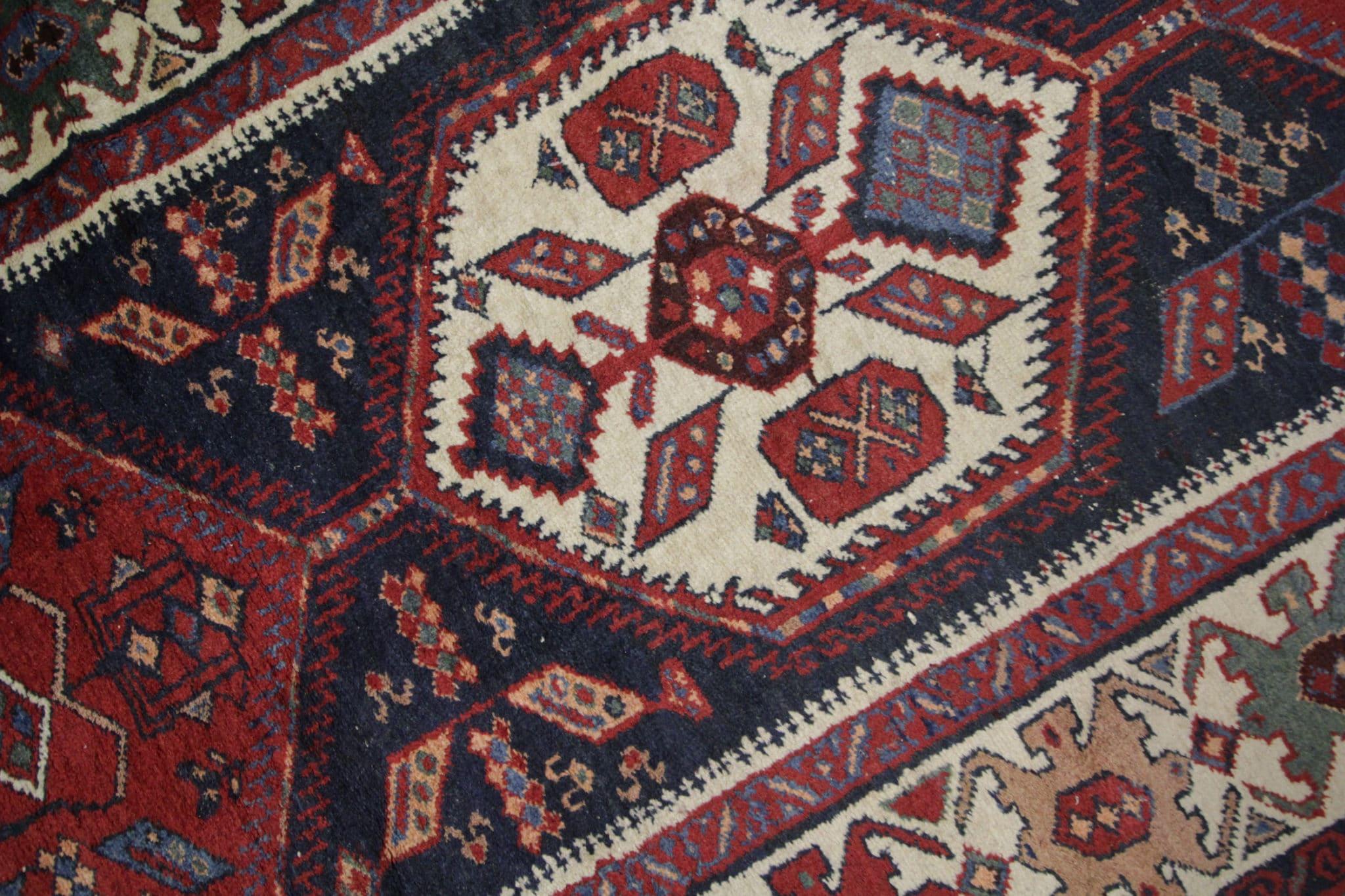 Indulge in timeless elegance with our vintage handmade rug carpet, a captivating addition to your living space. Skillfully hand-knotted in the 1970s, this rug boasts an exceptional tribal weave that exudes both charm and durability. Its exquisite