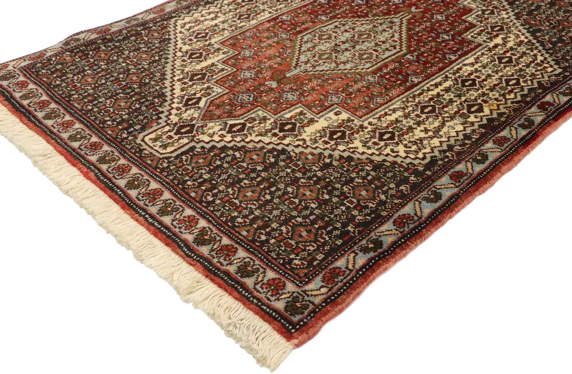75011, vintage Persian Sanadaj Accent rug, Kitchen, Foyer or Entry rug. This hand knotted wool vintage Persian Sanadaj accent rug features a centre medallion with anchor tip finials surrounded by an all-over geometric pattern. It is enclosed with a