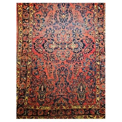 Tapis persan Sarouk du début du 20e siècle - motifs floraux en rouge et bleu marine