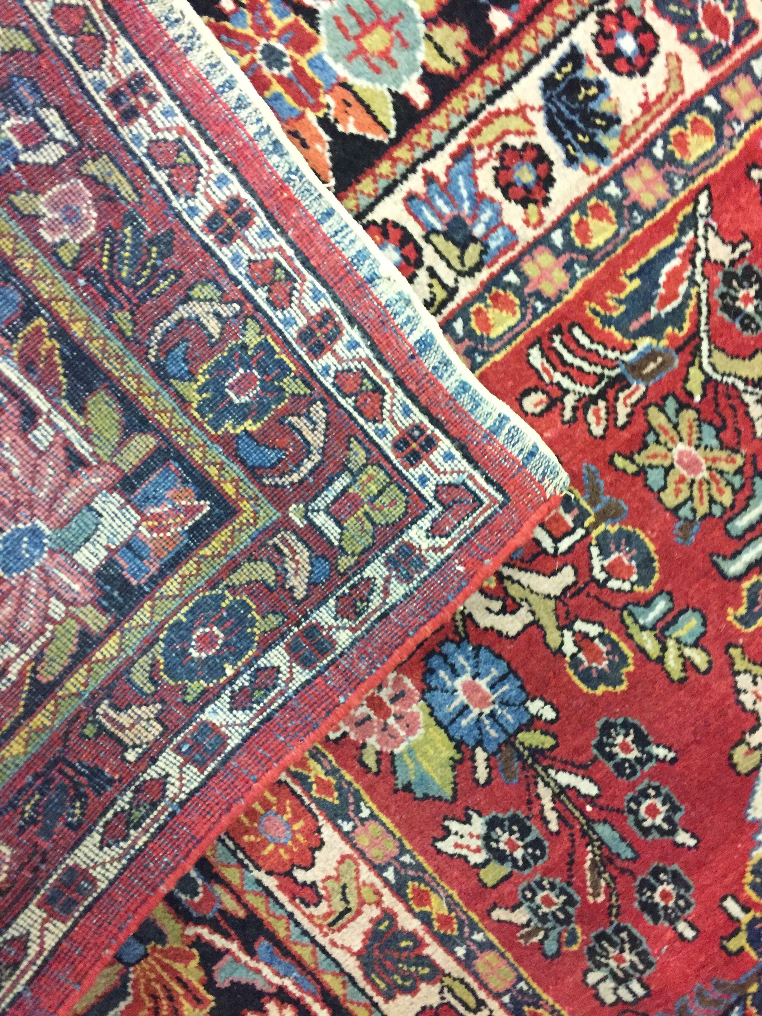 Vintage Persian Sarouk rug 9'2 x 11'9. Vintage handwoven Sarouk rug with a floral design on a terracotta field. The main field is filled with wonderful floral designs expertly hand knotted by skilled craftsmen. The field is surrounded by a main