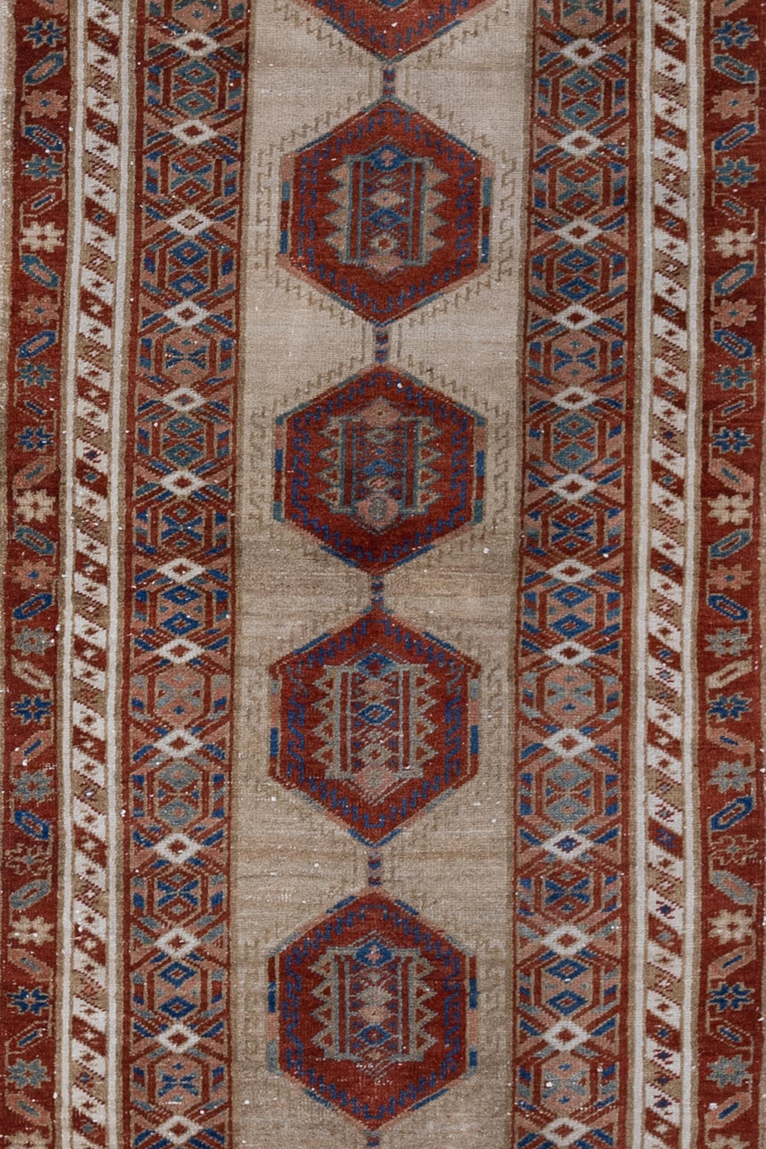 Age: early 20th century 

Colors: wheat, deep red, cobalt, petrol blue 

Pile: low-medium 

Wear Notes: 1

Material: wool on wool

Elegant and simple, this early 20th century camel Serab has a traditional geometric center and classic