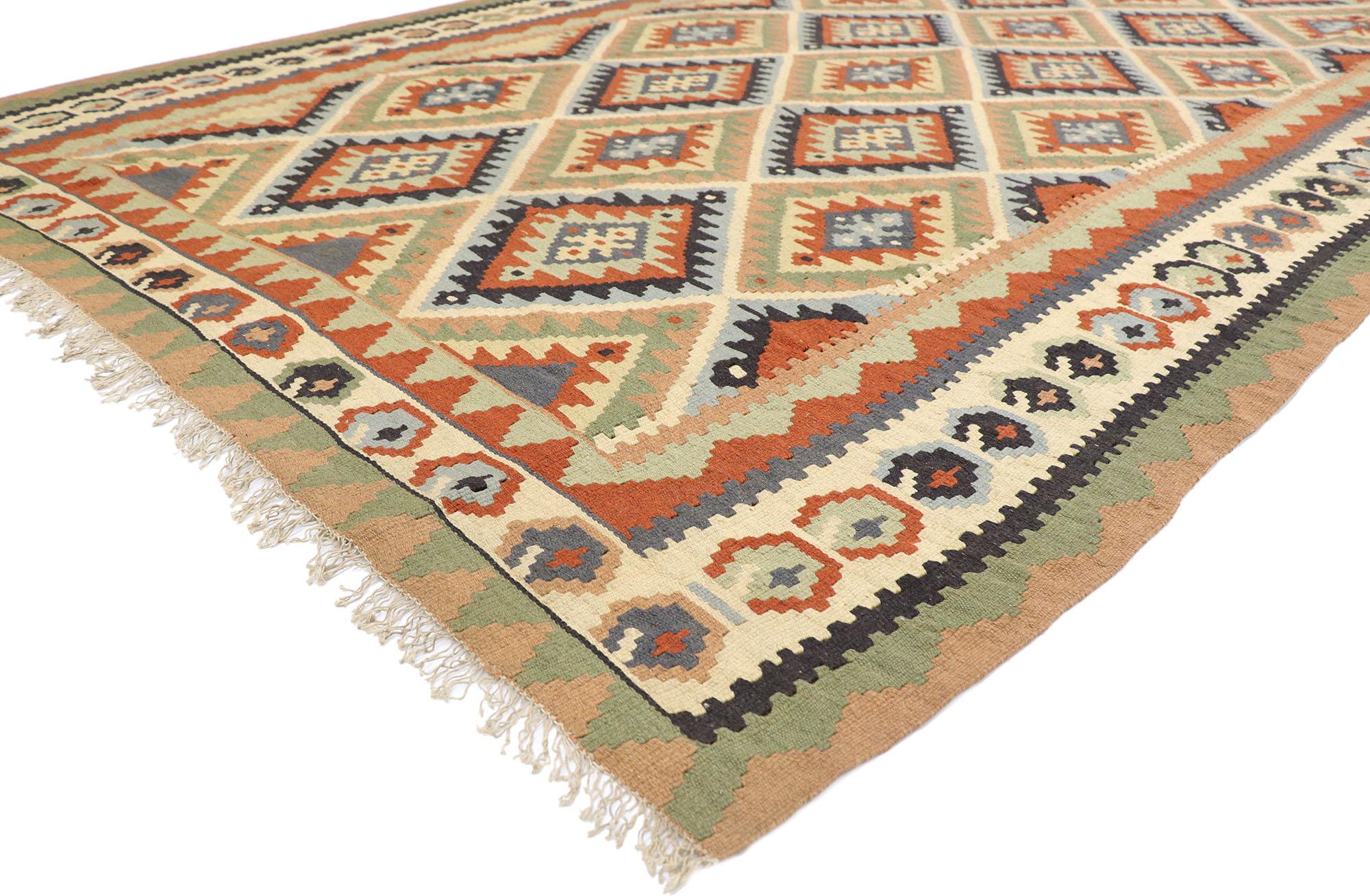77919 Vintage Persian Shiraz Kilim rug with Southwestern Tribal Style 06'09 x 10'01. Full of tiny details and a bold expressive design combined with vibrant colors and tribal style, this hand-woven wool vintage Persian Shiraz kilim rug is a