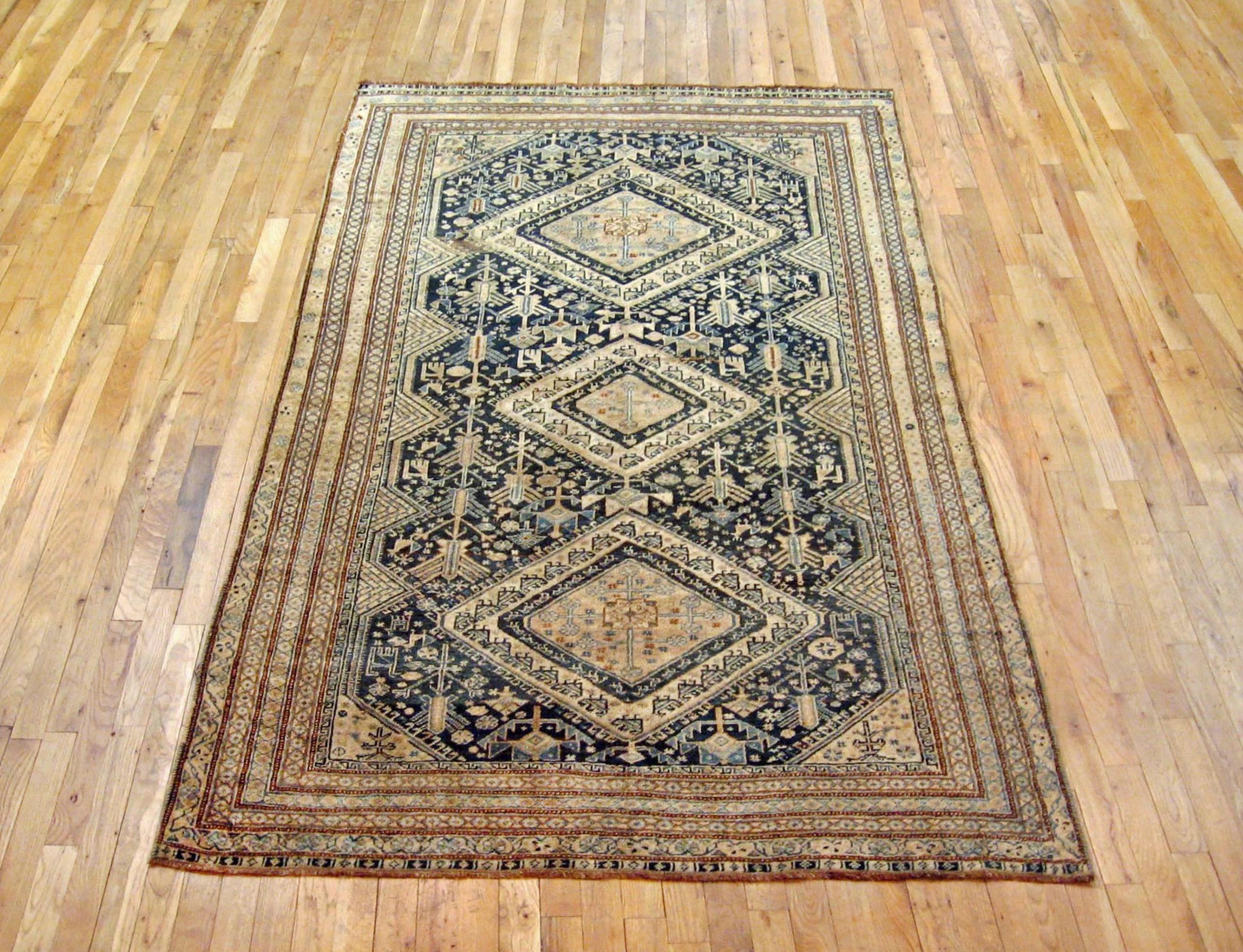 Antique Persian Shiraz oriental rug, in small size.

An antique Persian Shiraz oriental rug, size 7'9