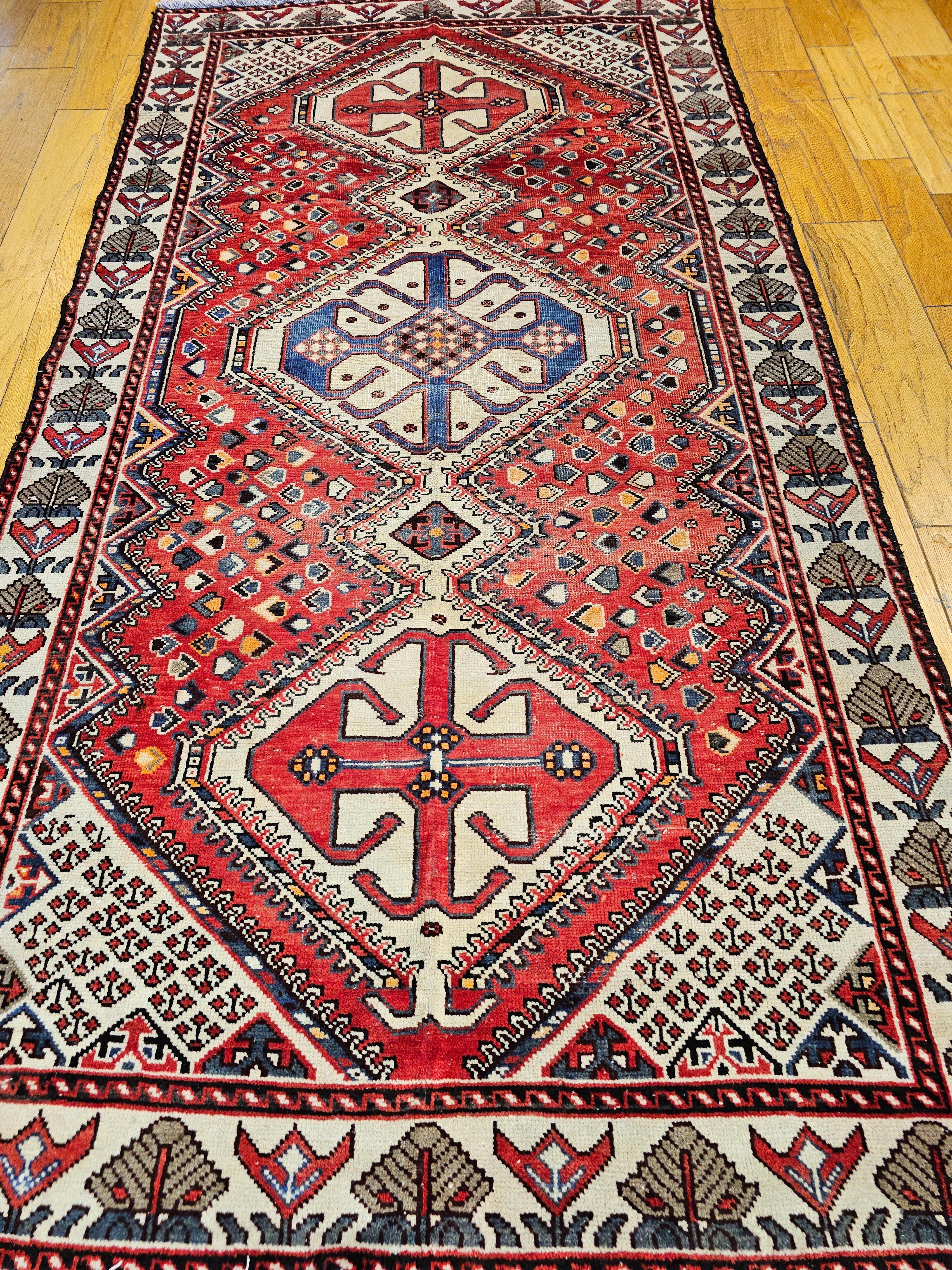  Vintage Persian Hand-Knotted gallery or room size rug from the Shiraz region of Western Persia circa the mid 1900s.  The tribal design rug, similar to Qashqai rugs, comes with traditional three vertical medallions which is “Shiraz Signature”