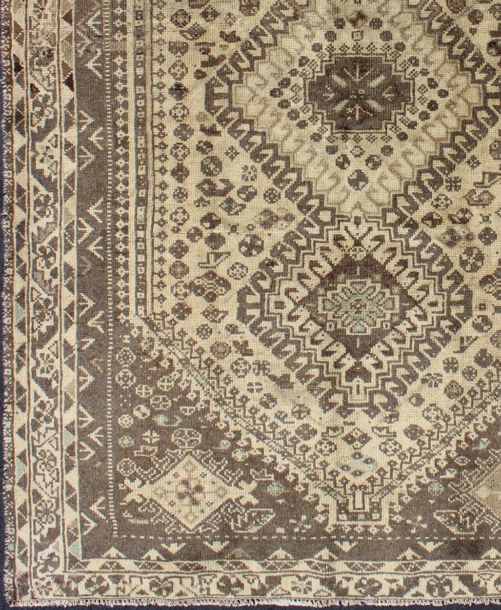 Vintage hand-knotted Persian Shiraz, rug H-1211-40, country of origin / type: Persian / Tribal, circa mid-20th century, 

This vintage Persian rug features a central medallion design in a neutral color palette with brown outlines. The geometric,