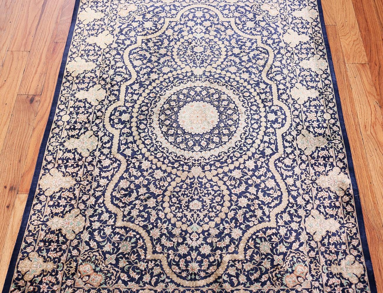 A beautiful and finely woven blue background color vintage Persian silk Qum rug, country of origin / rug type: Persian rug, date: circa vintage mid-20th century - Size: 3 ft 3 in x 4 ft 10 in (0.99 m x 1.47 m).