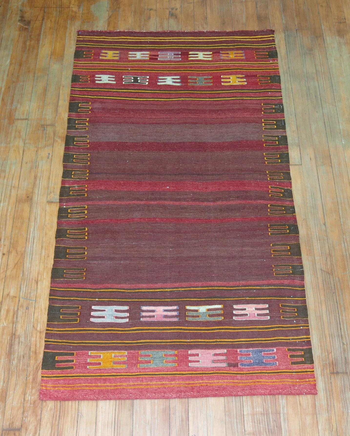 A vintage Persian Kilim scatter sofreh flat-weave from the middle of the 20th century.

Sofrehs are woven by Persian tribes as part of the dowry, used as floor spreads on which they would offer food for special guests. Their diminutive size and