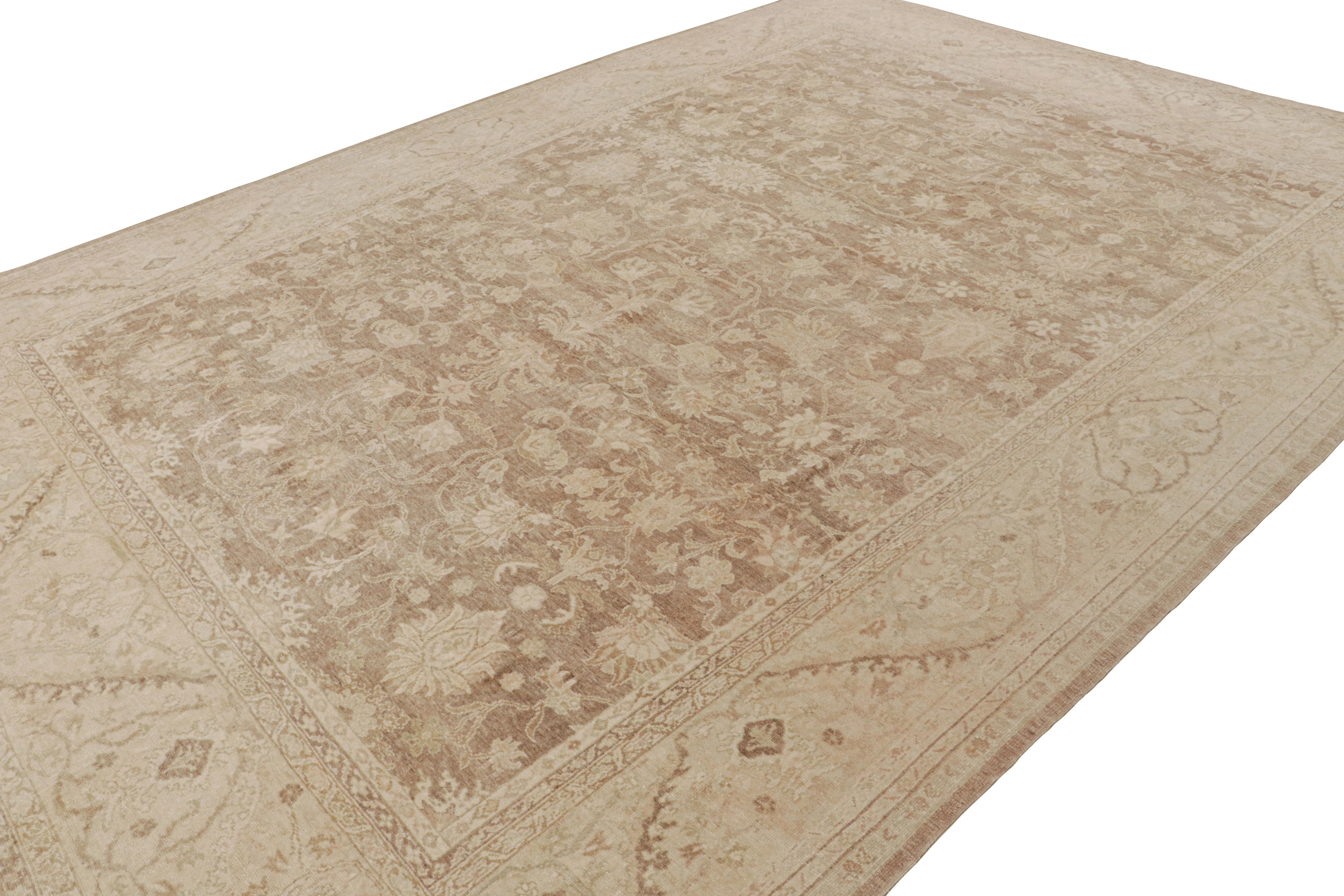 Hand-knotted in wool, this 10x14 vintage Persian Sultanabad rug in Beige-brown with taupe tones, features intricate floral patterns with a slight European sensibility to them.  

On the design: 

Drawing inspiration from the fine European