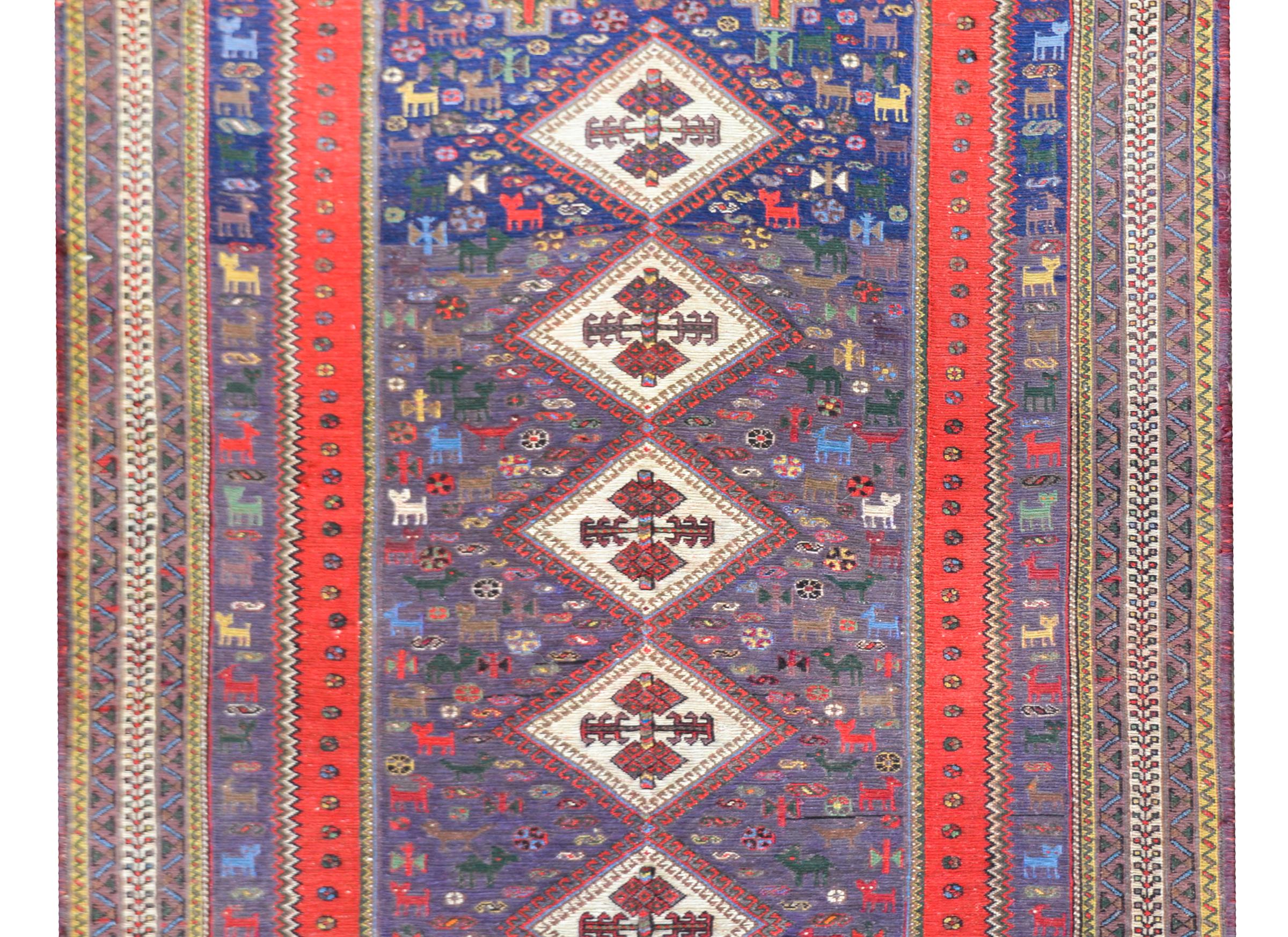 A wonderful mid-20th century Persian Sumak rug with five diamond medallions with stylized flowers, and living amidst a fantastically woven field of more stylized flowers and animals. The border is beautiful woven in several thin striped with petite