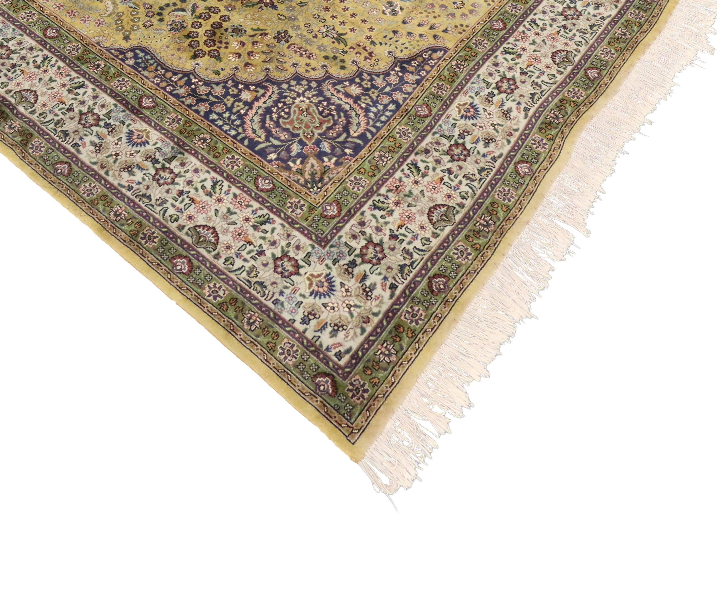76500 Vintage Persian Tabriz Area rug with Arabesque Art Nouveau style. This hand-knotted wool vintage Persian Tabriz rug features a central medallion of mint, sage mocha and cream floating in a field of light saffron dotted with delicate flowers.