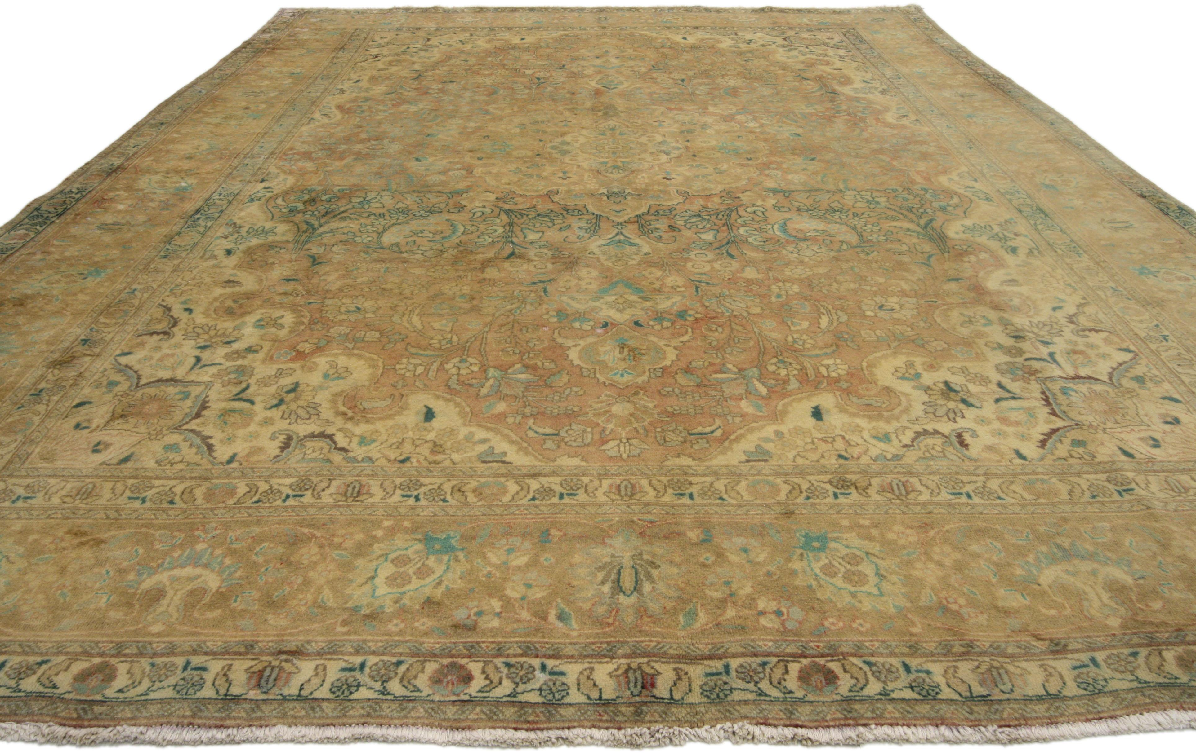 76433, vintage Persian Tabriz Area rug with traditional style. This hand-knotted wool vintage Persian Tabriz rug features an intricate cusped medallion flanked with palmette finials surrounded by all-over florals, blooming vines and palmettes. It is
