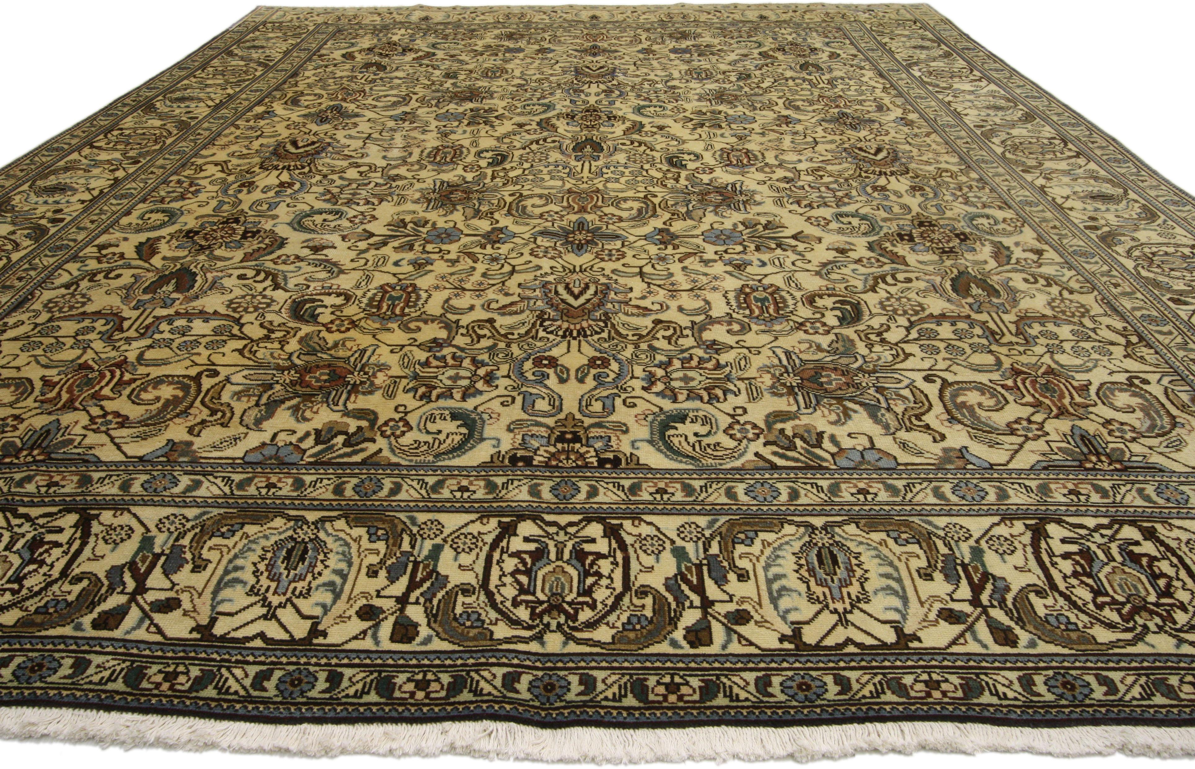 76473, vintage Persian Tabriz area rug with traditional style. This hand-knotted wool vintage Persian Tabriz rug features an all-over pattern surrounded by a classic border creating a well-balanced and timeless design. This vintage Persian Tabriz