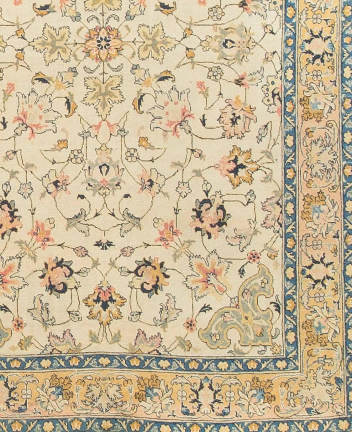 Vintage Persian Tabriz, circa 1940, size: 6'1 x 9'2. A lovely soft and spacious 1940s handwoven vintage Tabriz rug. The equally soft border enclosed by two light blue guard borders helps complete the overall composition of lightness.
 