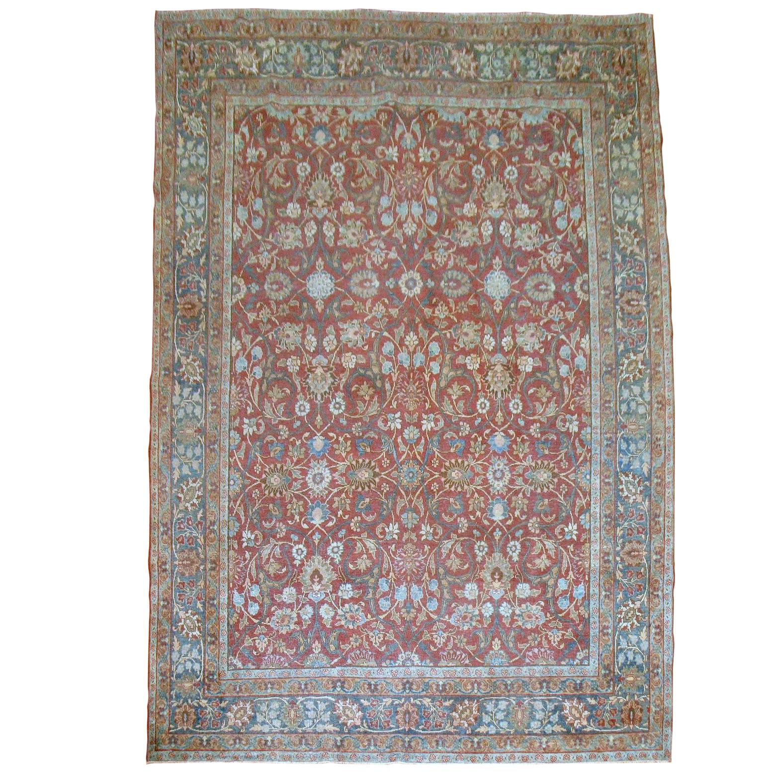An authentic room-size handmade Persian Tabriz rug. Red field, various shades of blues and greens.

7'9'' x 11'4''