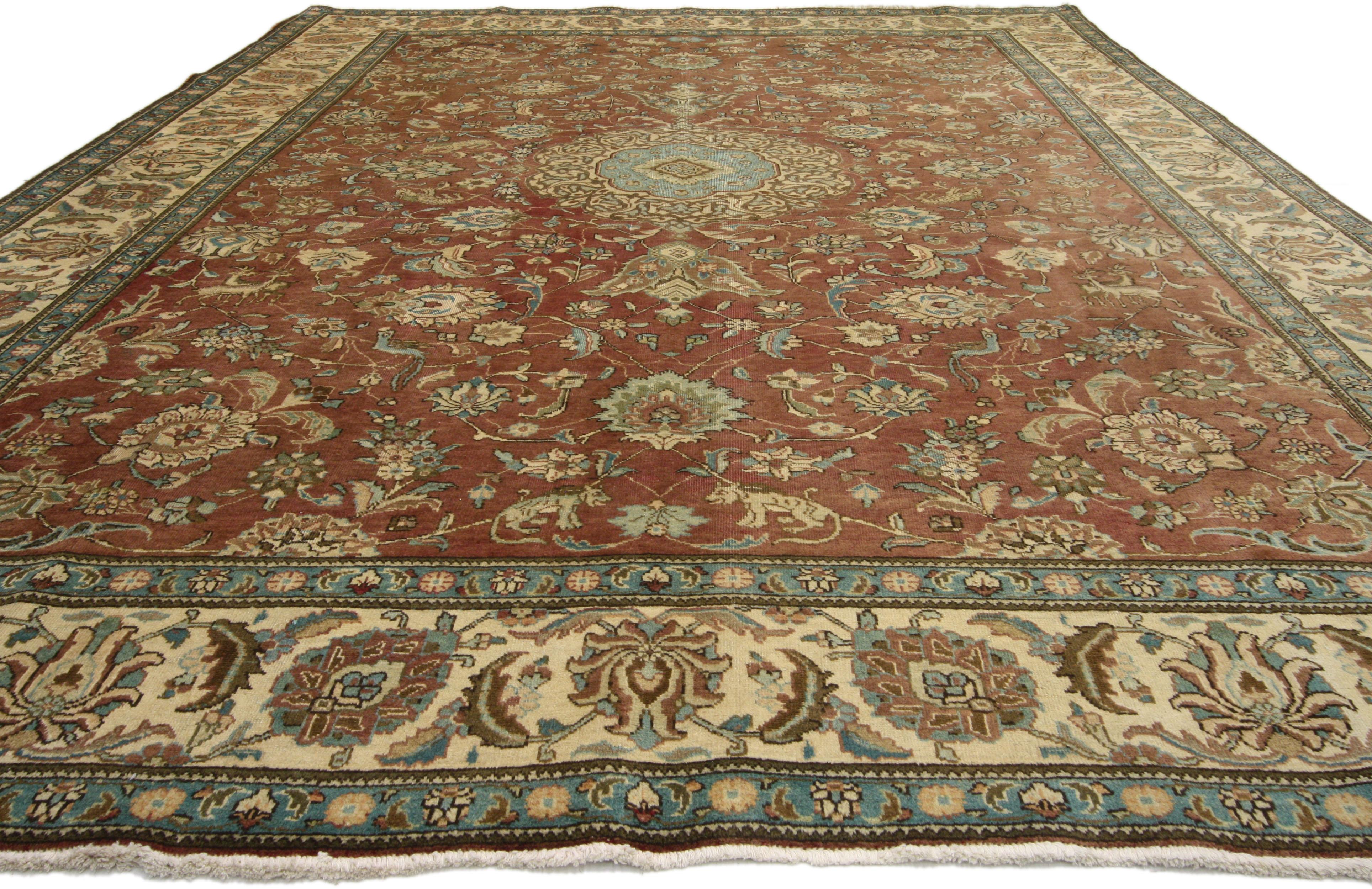 76286, vintage Persian Tabriz gallery rug with hunting scene and medieval style. This hand-knotted wool vintage Persian Tabriz rug features an eight-point cusped central medallion outlined in filigree edging among an inconspicuous hunting scene