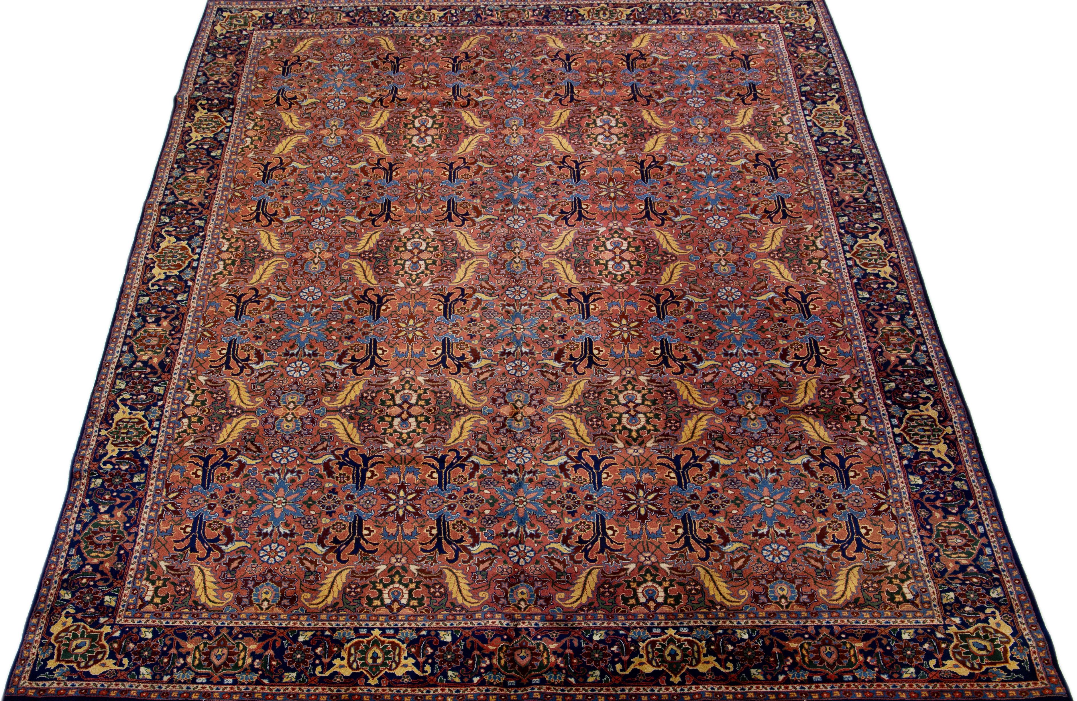 Beautiful Vintage Tabriz hand-knotted wool rug with a tan color field. This piece has a dark blue frame, multicolor accents, and a gorgeous all-over floral design.

This rug measures 8'11